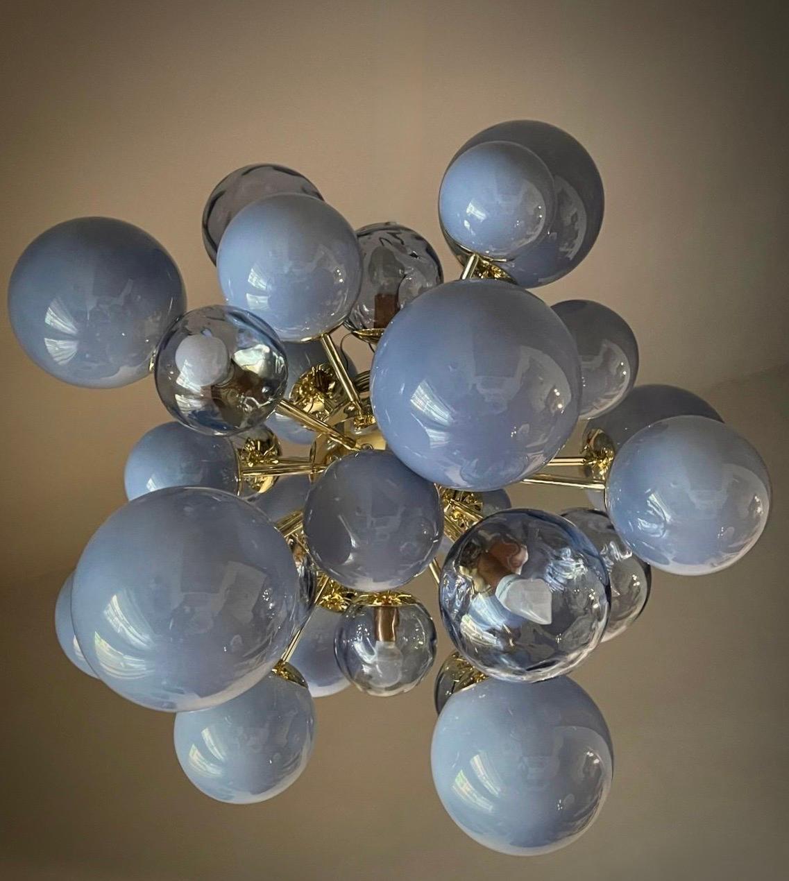 Exciting pastel blue color gradation for this Murano chandelier, different shades together for this beautiful color. Note the asymmetrical design.

Something truly incredible this Murano chandelier. As in a photograph of an infinitesimal moment