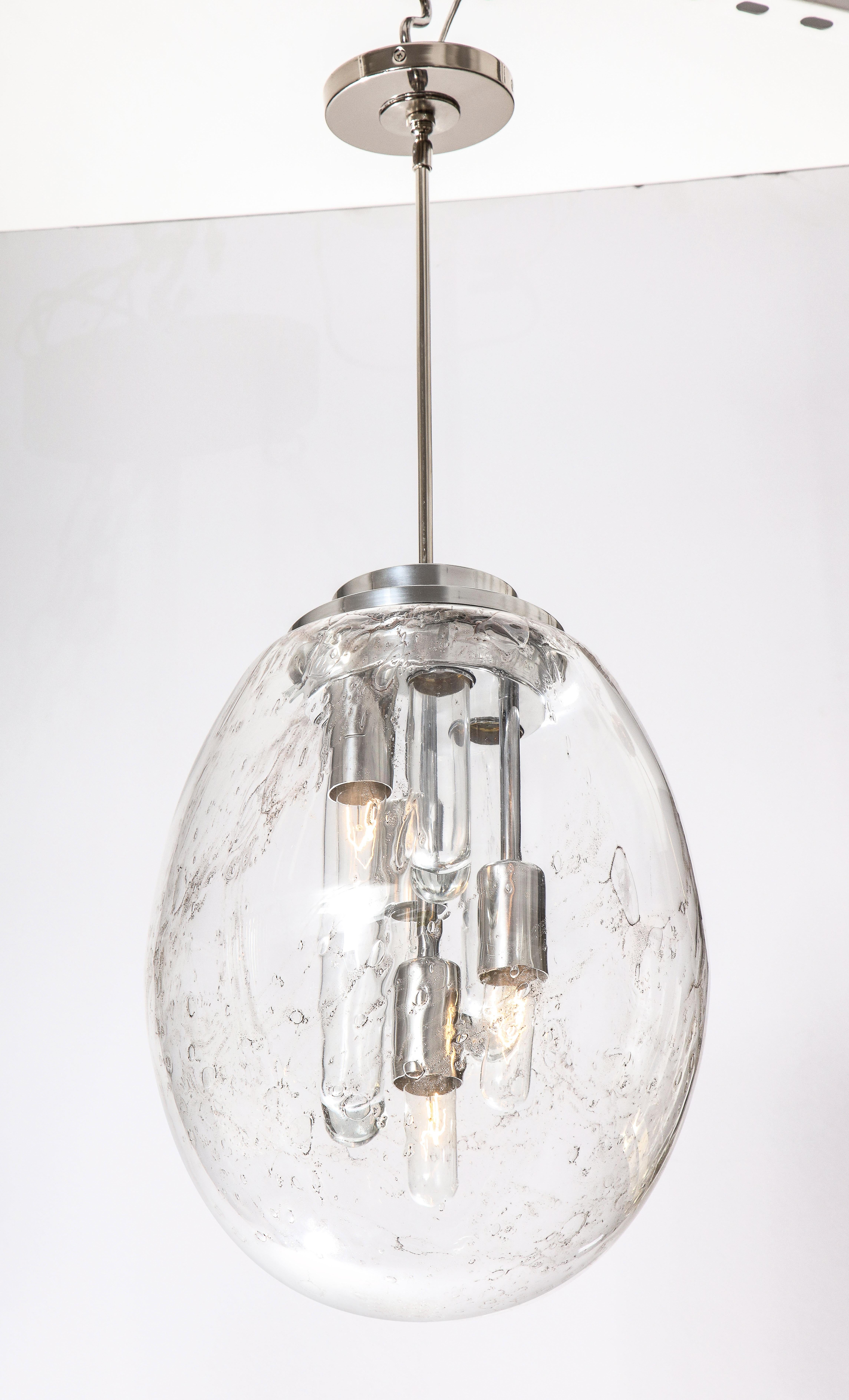 Large oval hand blown Murano glass pendant light by Doria.
The Murano glass has slight grey veining and has been newly rewired for the US.
It has four standard light sockets and there are three glass tubes.
The 14