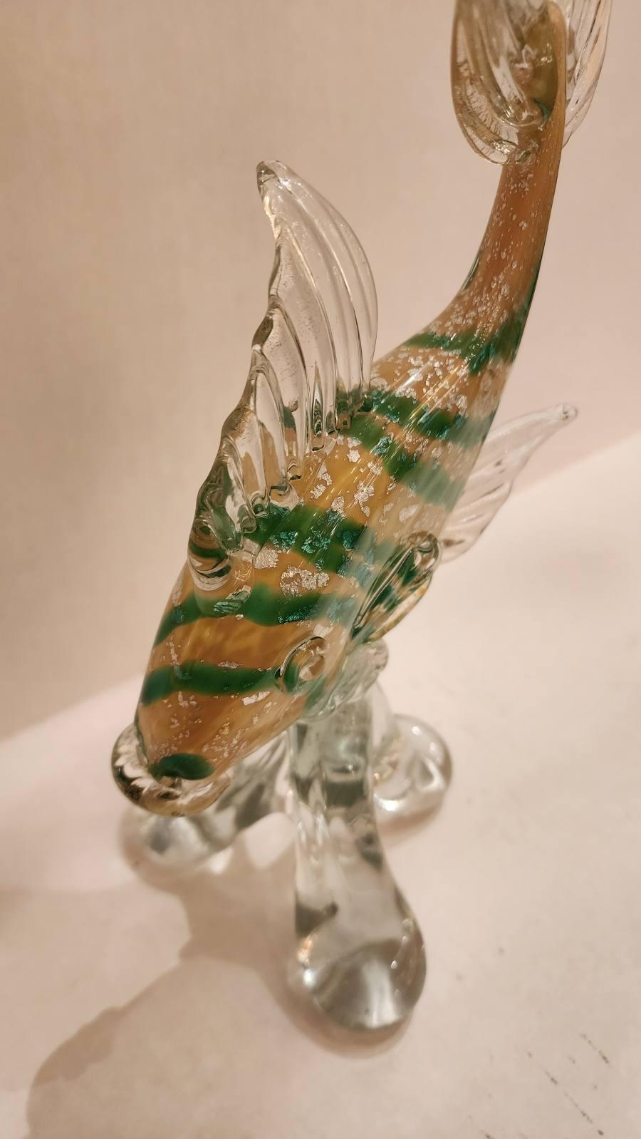 This listing features a beautiful yellow and green stripped fish with silver leaf flake details. Murano glass dates back to the 6th century AD with the island of Murano becoming a prominent center for glassmaking. The process of creating Murano