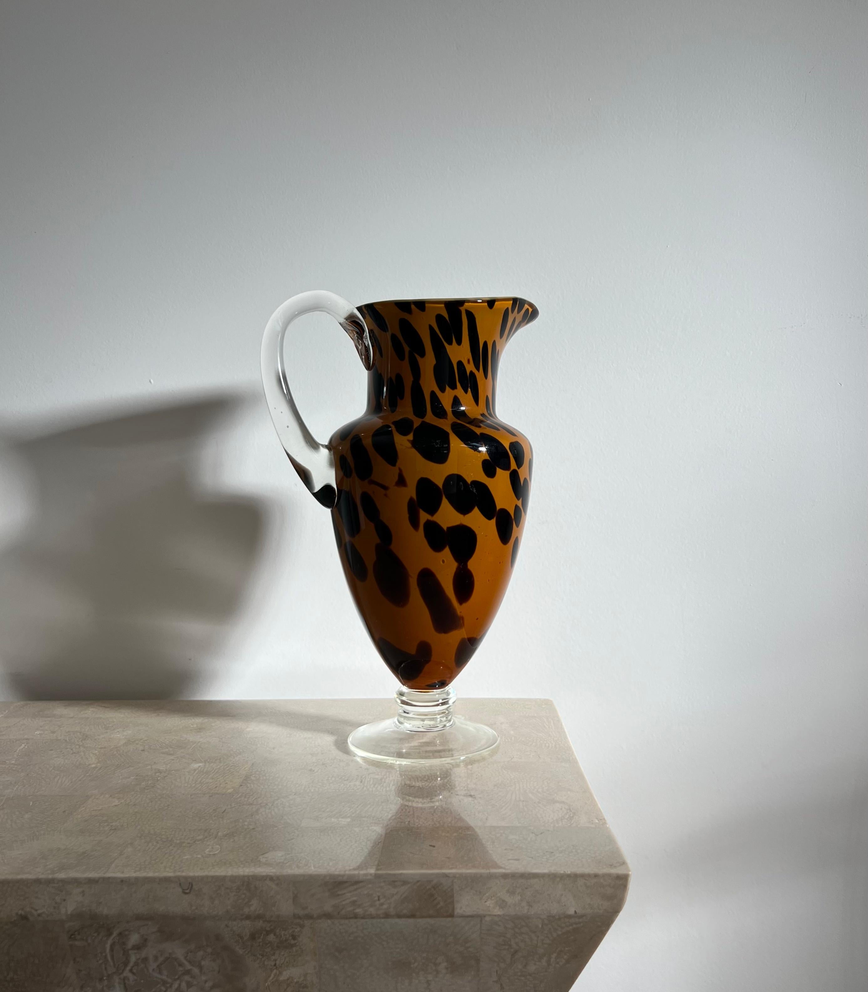 A rare Murano style art glass pitcher, Italy 1990s. Tones of saffron and espresso; motif is not totally dissimilar to leopard print. Base and handle are thick transparent glass. Minor signs of age consistent with use but no outward or glaring flaws;