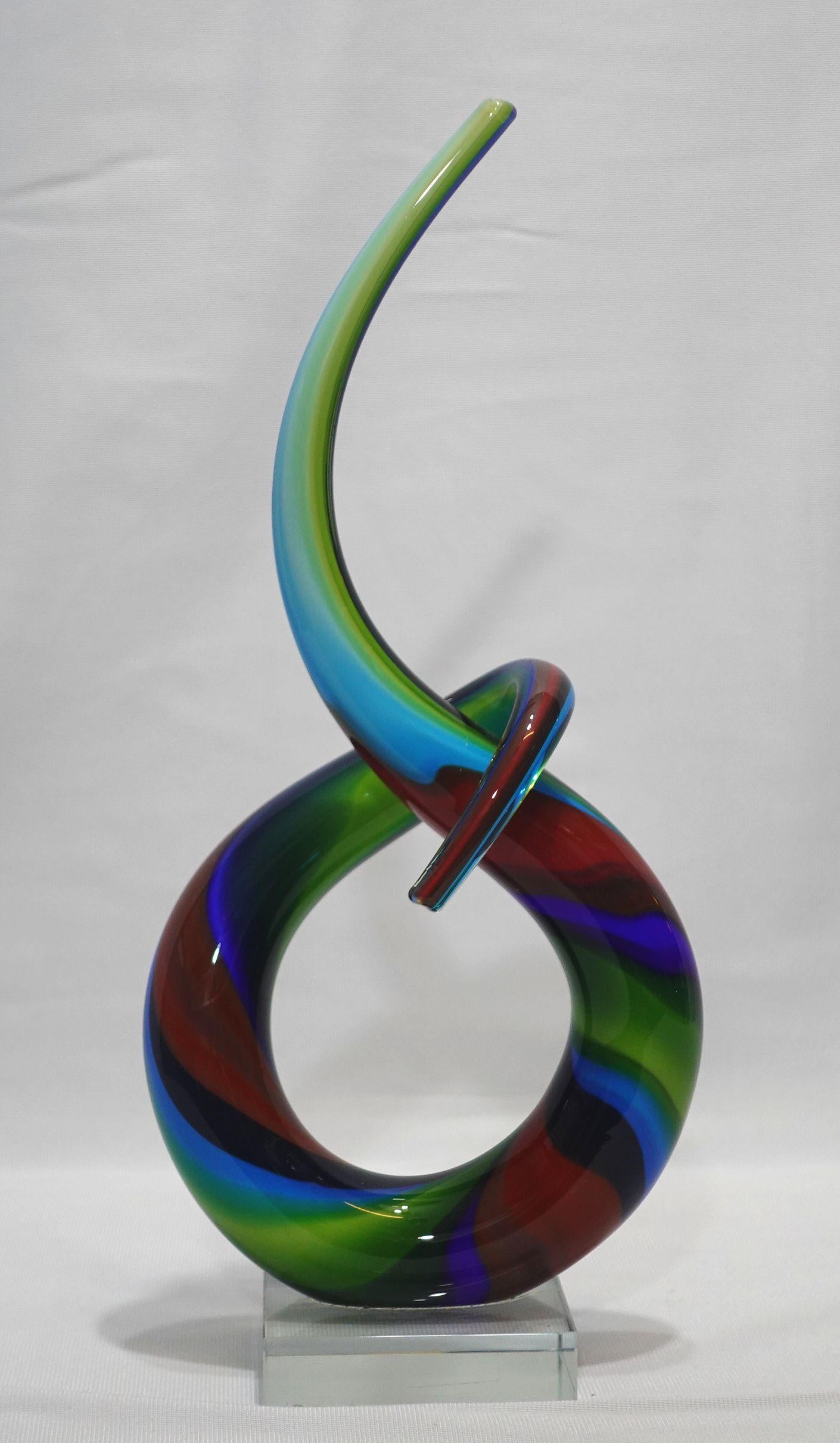 Beautiful and unique Murano Style Entwined Sculpture Italian Art Glass with rainbow colors to form an elegant sculpture set on a square glass base.