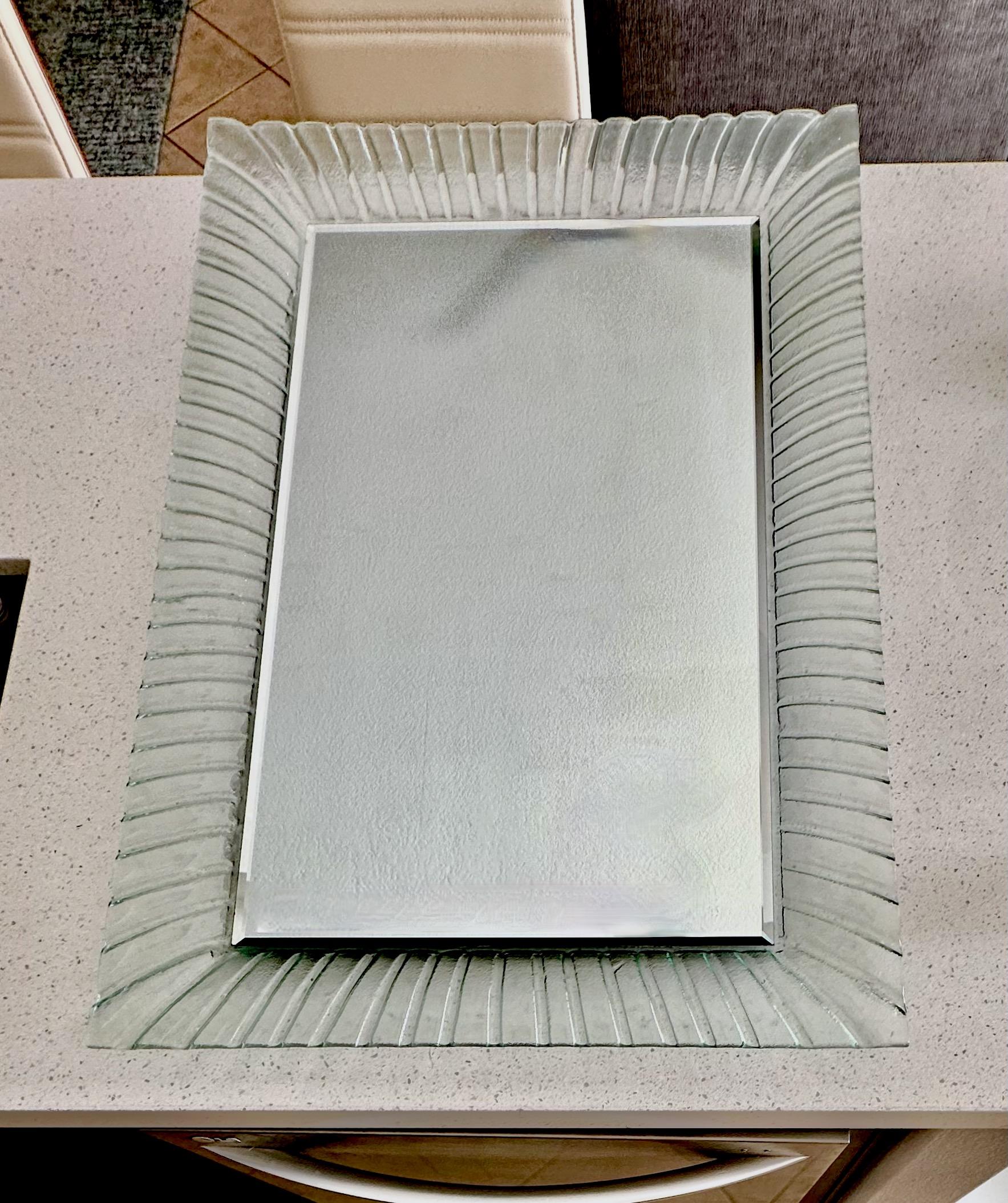 One-piece molded Modern Murano style glass frame with an undulating edge in a translucent faint green. Hardware on the reverse allows for this piece to hang vertically or horizontally. 