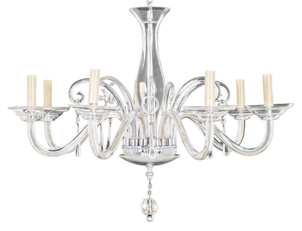 Murano style seven-arm colorless glass chandelier, the central vasiform baluster issuing seven arms with circular drip pans and seven scrolls, each scroll with pendant ring and drop. 

Dimensions: 20