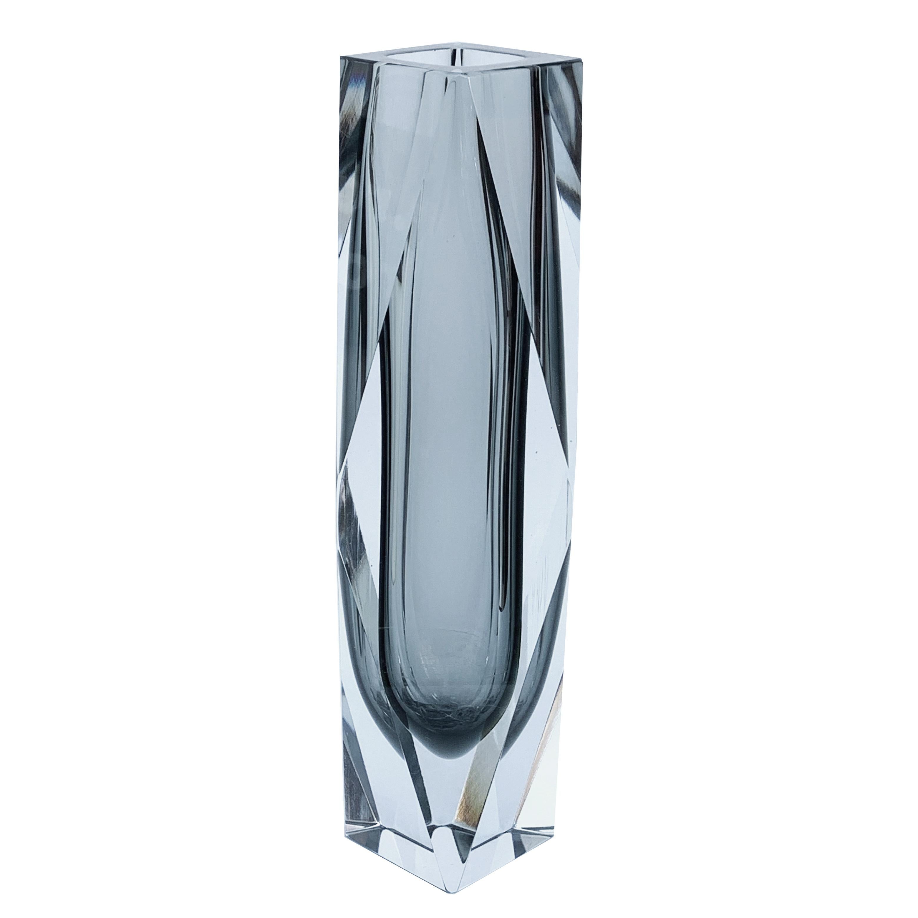 Large multi-faceted glass vase by Mandruzzato.
This beautiful piece is very elegant thanks to the delicate line and the smoky-transparent color. It is rare, not only for its shape but also for its dimensions: indeed the item is a little bit bigger