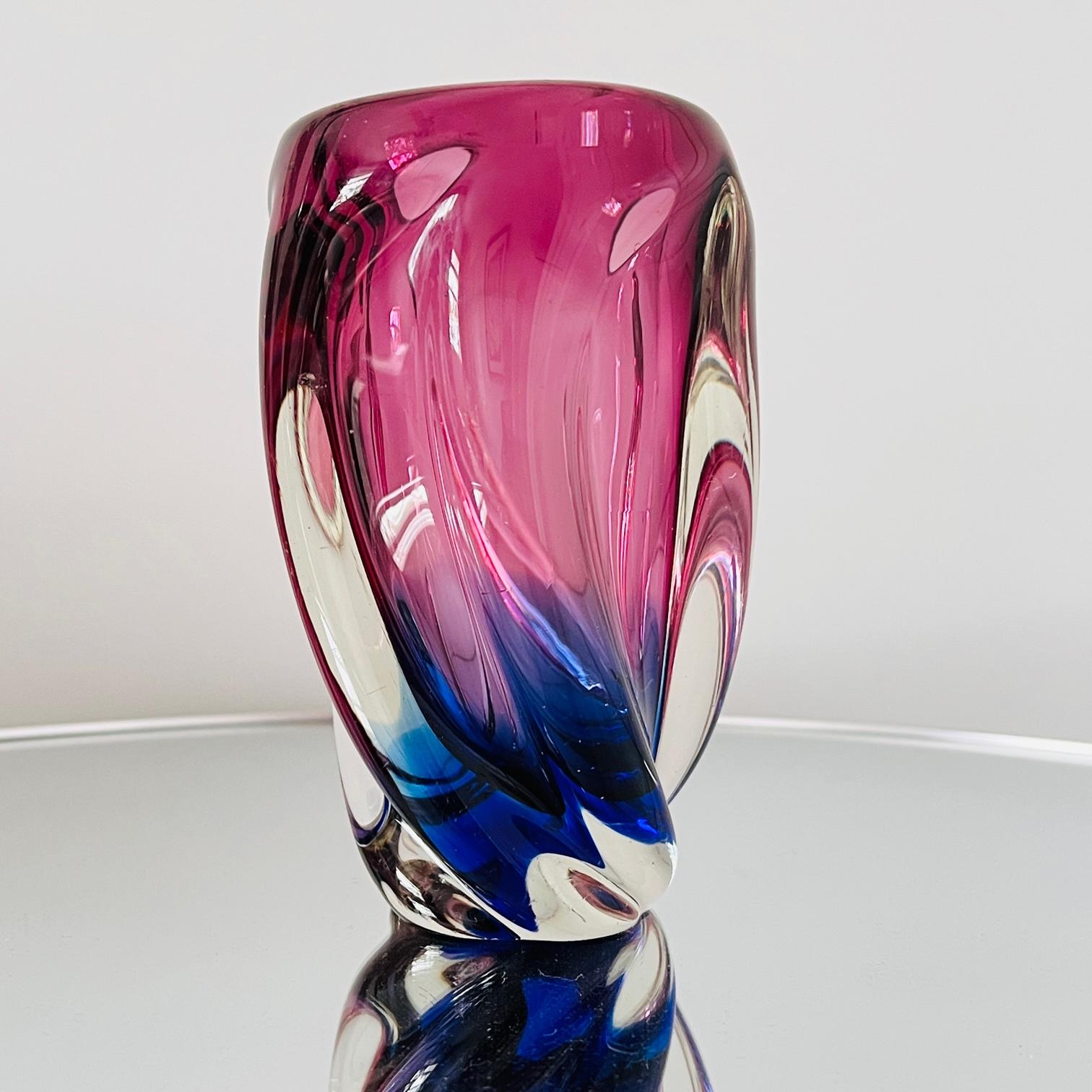 1960's Italian vase comprised of handblown Murano Glass in hues of amethyst purple, violet, and cobalt blue. The heavy-set glass features a fluid swirl design using the Sommerso technique whereby the colors are cased within the glass and submerge
