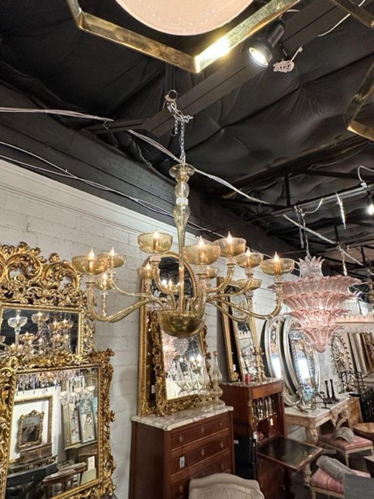 Gorgeous Murano tabaco glass 12 arm chandelier with rostri elements. The chandelier has been professionally rewired, comes with matching chain and canopy. It is ready to hang!