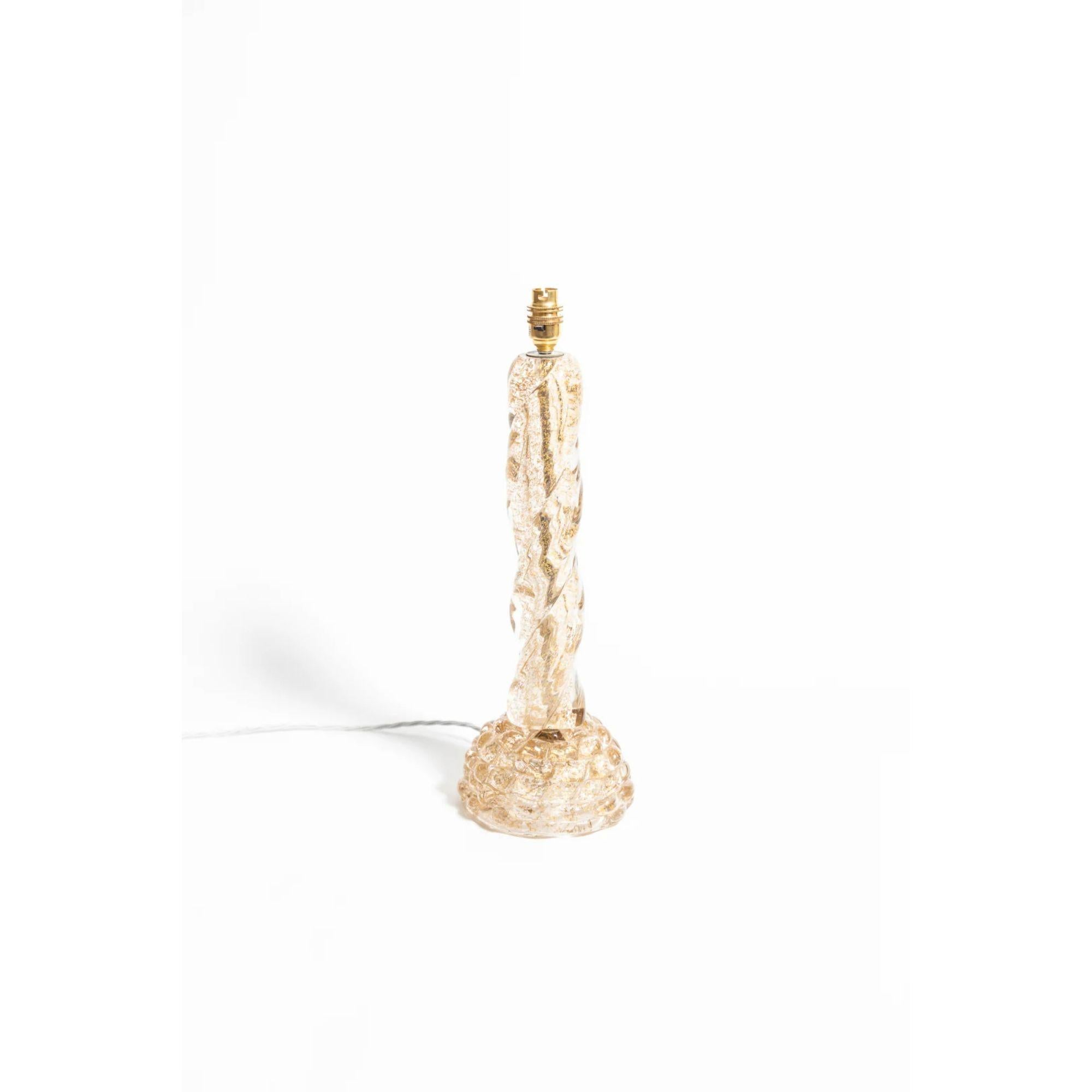A sculptural table lamp in Murano glass and gold leaf by Ercole Barovier, 1940s.

Ercole Barovier began his personal aesthetic transition toward modernism in the 1930s with his Primavera series of vases - idiosyncratic milky-white and clear glass