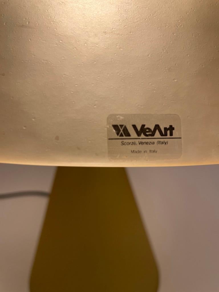 Beautiful and large mushroom lamp in mustard color glass and golden metal parts.
The frosted glass is slightly hammered with an organic look. 
Ve-Art was founded in 1965 by Sergio Biliotti & Ludovico Diaz de Santillana who married Anna Venini, the