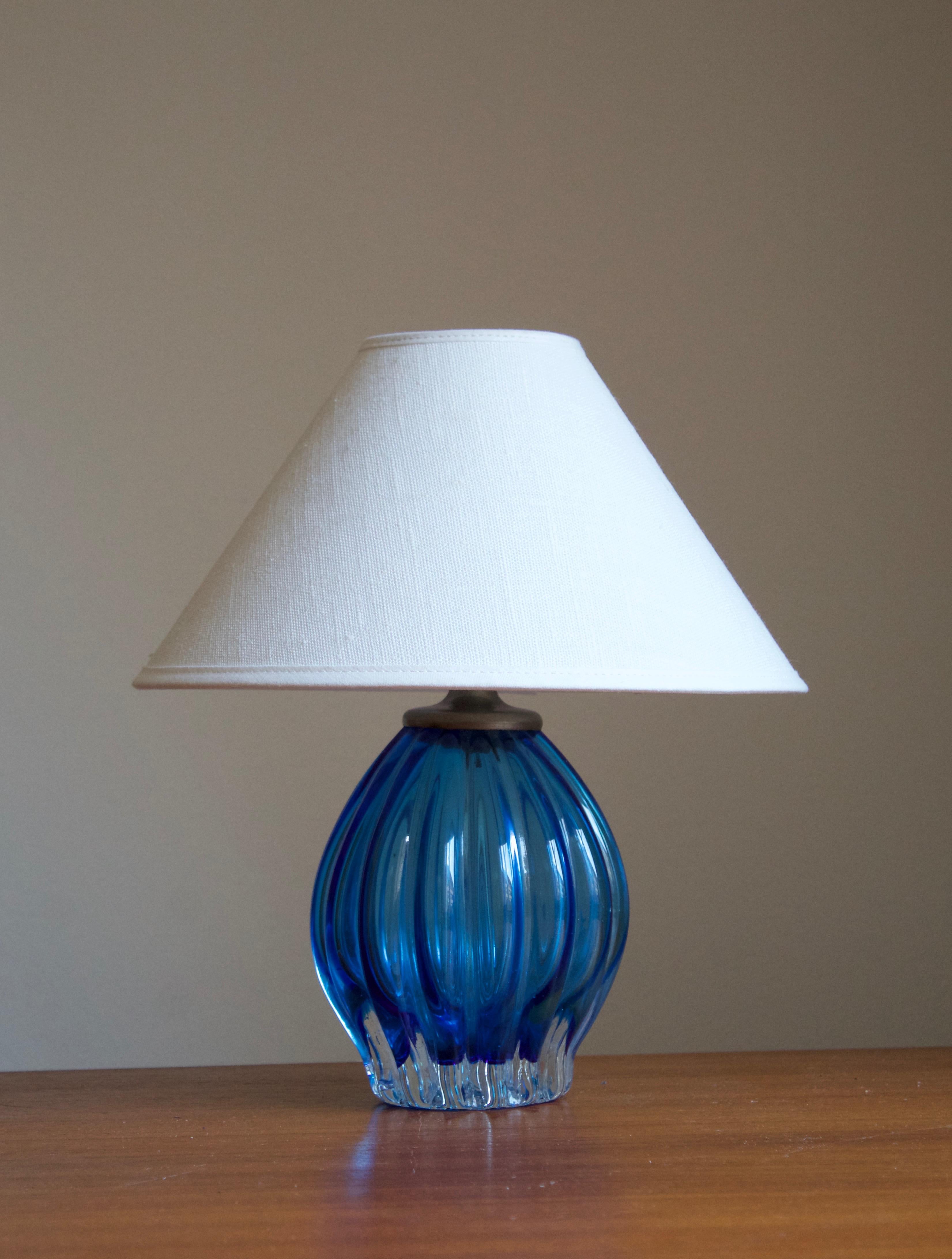 A table lamp. Designed and produced in Murano glass, Italy, 1940s.

Features colored blue glass and metal socket. 

Stated dimensions exclude lampshade. Height includes socket. Sold without lampshade.