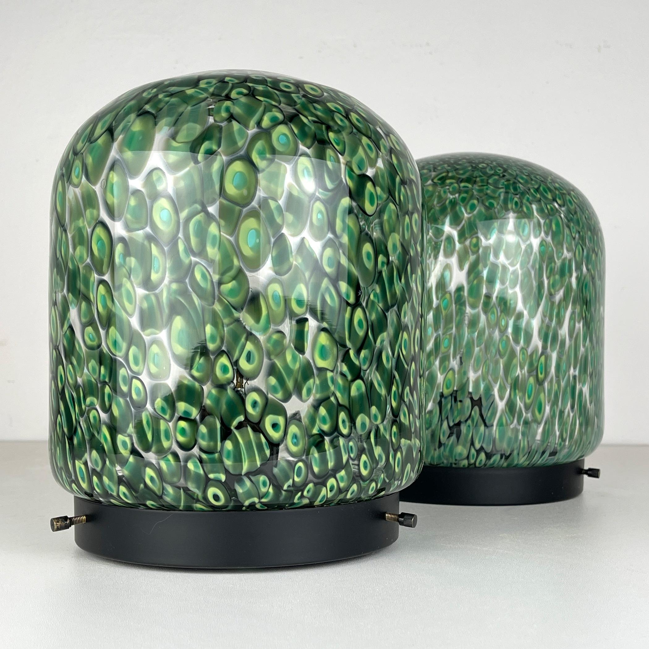 Revitalize your space with this exquisite pair of green table lamps, designed by Gae Aulenti for Vistosi in Italy during the 1970s. These stylish table lamps are a true blend of craftsmanship and design. Handcrafted, the lampshades are a genuine