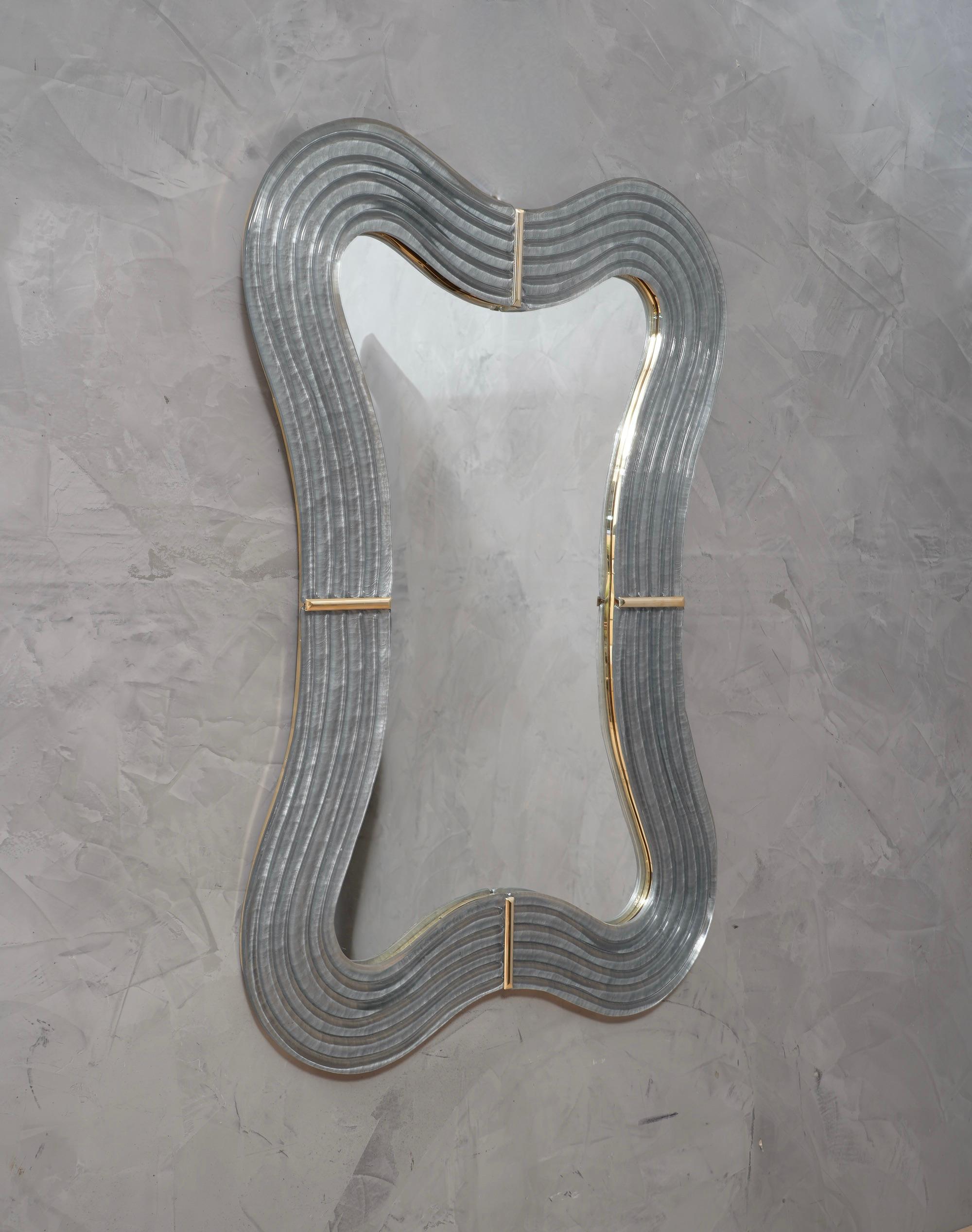 Stunning wall mirror in blazing Murano teal glass color of Venice. A mirror that alone will furnish your home environment.

The mirror is composed of a perimeter frame in Murano glass in aqua green color, which forms curves in its design, which are