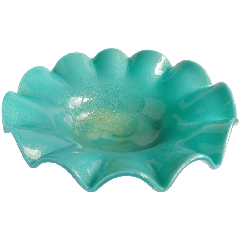 Very large vintage Murano hand blown teal green and gold flecks Italian art glass ruffled rim, footed centerpiece bowl. Attributed to the A.Ve.M. (Arte Vetraria Muranese) company. The piece sits on a clear glass foot. Midcentury era. The orange