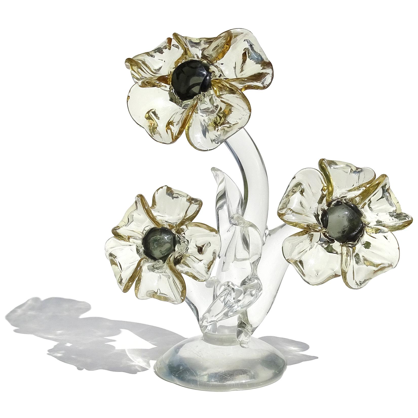 Beautiful large vintage Murano hand blown Italian art glass flowering plant sculpture. The piece has 3 very large flowers with clear leafs and base. Created with some Neodymium glass, which changes color from daylight to indoor fluorescent lighting.