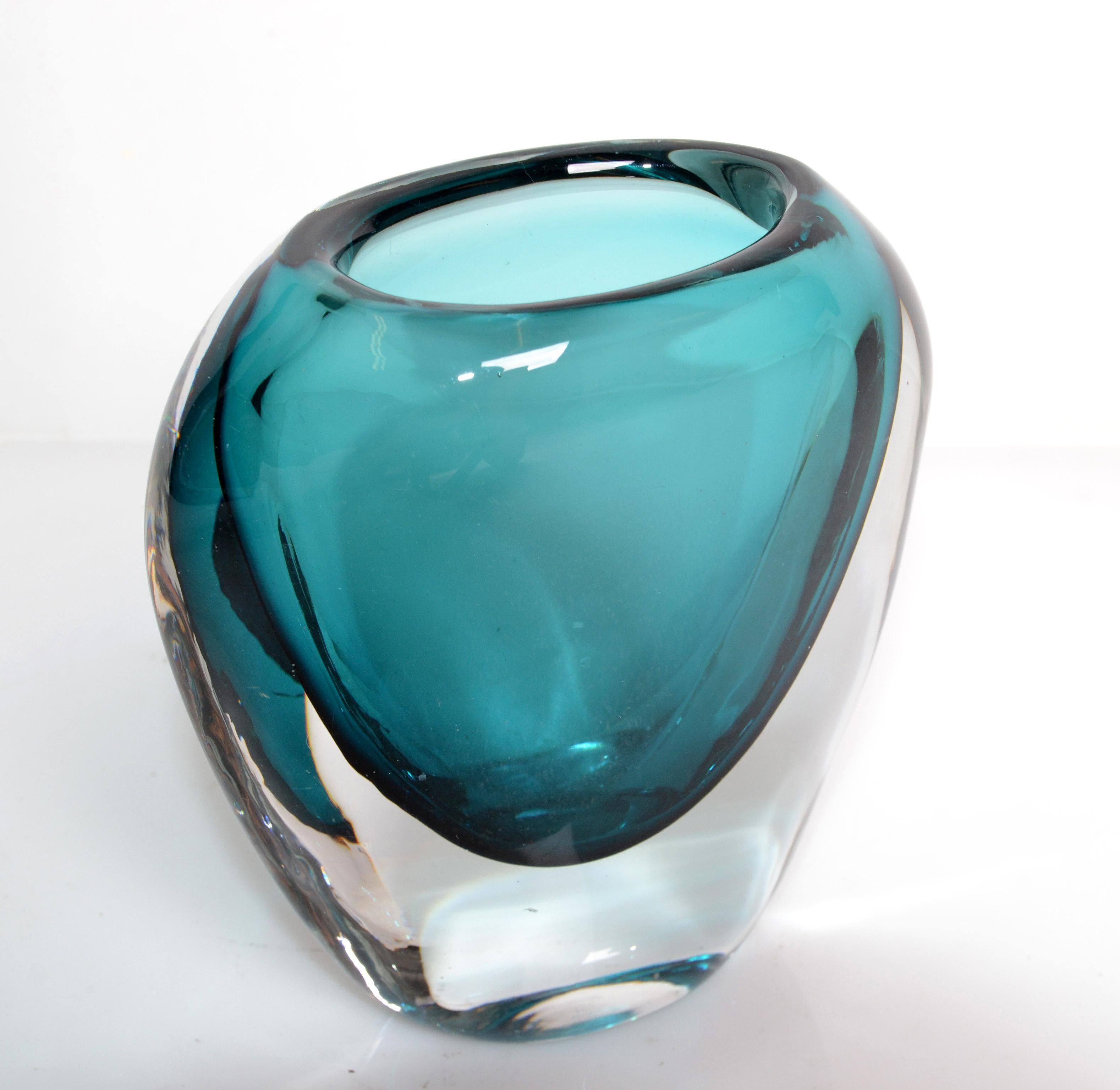 Murano blown art glass vase in turquoise blue and transparent glass from Italy.
The opening with 2.25 x 1.5 inches width is for a little bouquet.
Mid-Century Modern unique glass art very elegant and practical.
