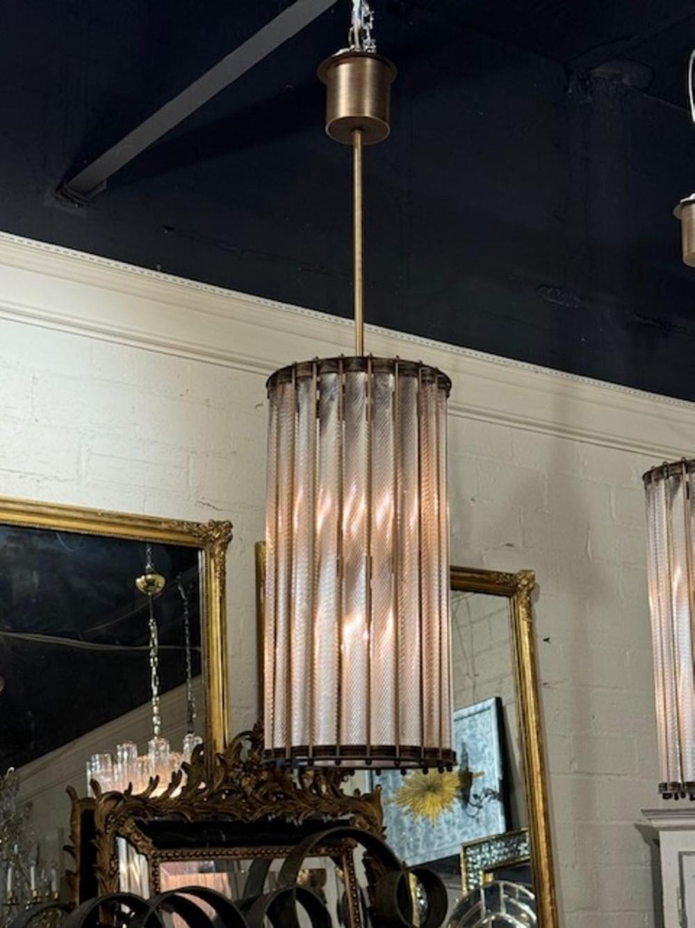 Modern Murano twist glass lanterns with antique brass frames. The chandelier has been professionally rewired, comes with matching chain and canopy. It is ready to hang!