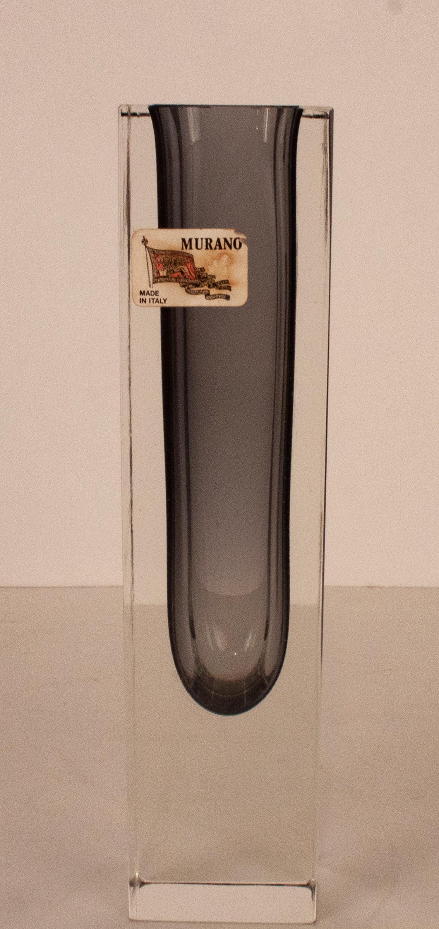 Murano vase in clear and gray mouth blown art glass. Italian design, 1960s.
Measures: 5 x 5 cm. Height 20cm.
With its original label
In excellent condition.