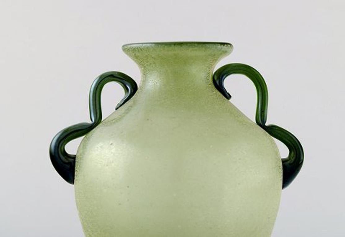 Murano vase with handles in light green mouth blown art glass, 1960s.
In perfect condition.
Measures: 18.5 x 15 cm.