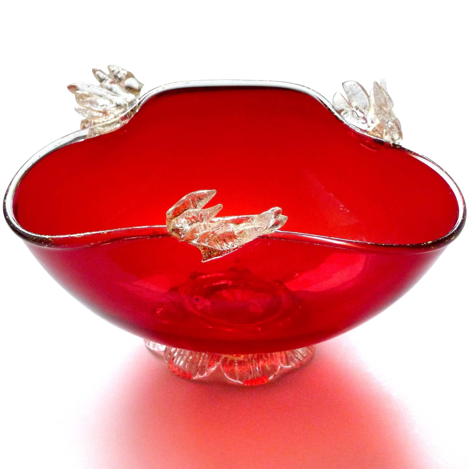 Beautiful vintage Murano handblown red and applied gold leaves Italian art glass footed candy bowl and dish. Created in the Venetian style, dating to the 1930s-1940s. The dish has an applied foot, and gold leaf all along the rim. Can be used as a