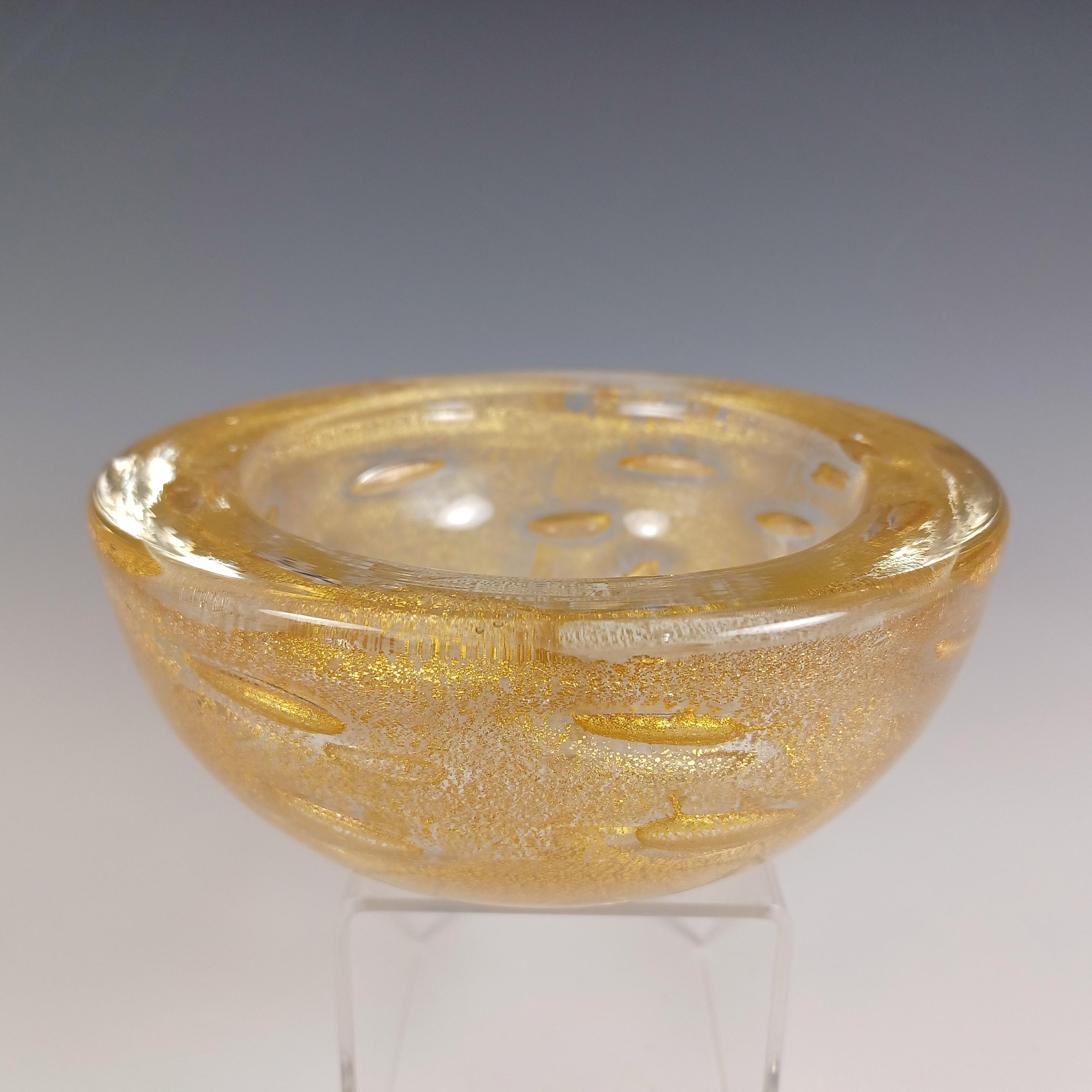 Here is a wonderful 1950/60's Venetian glass bowl/ashtray, made on the island of Murano, near Venice, Italy. Has lots of gold leaf inclusions encased in the glass, as well as a large bubble pattern.

Please note: the plastic stand is for display