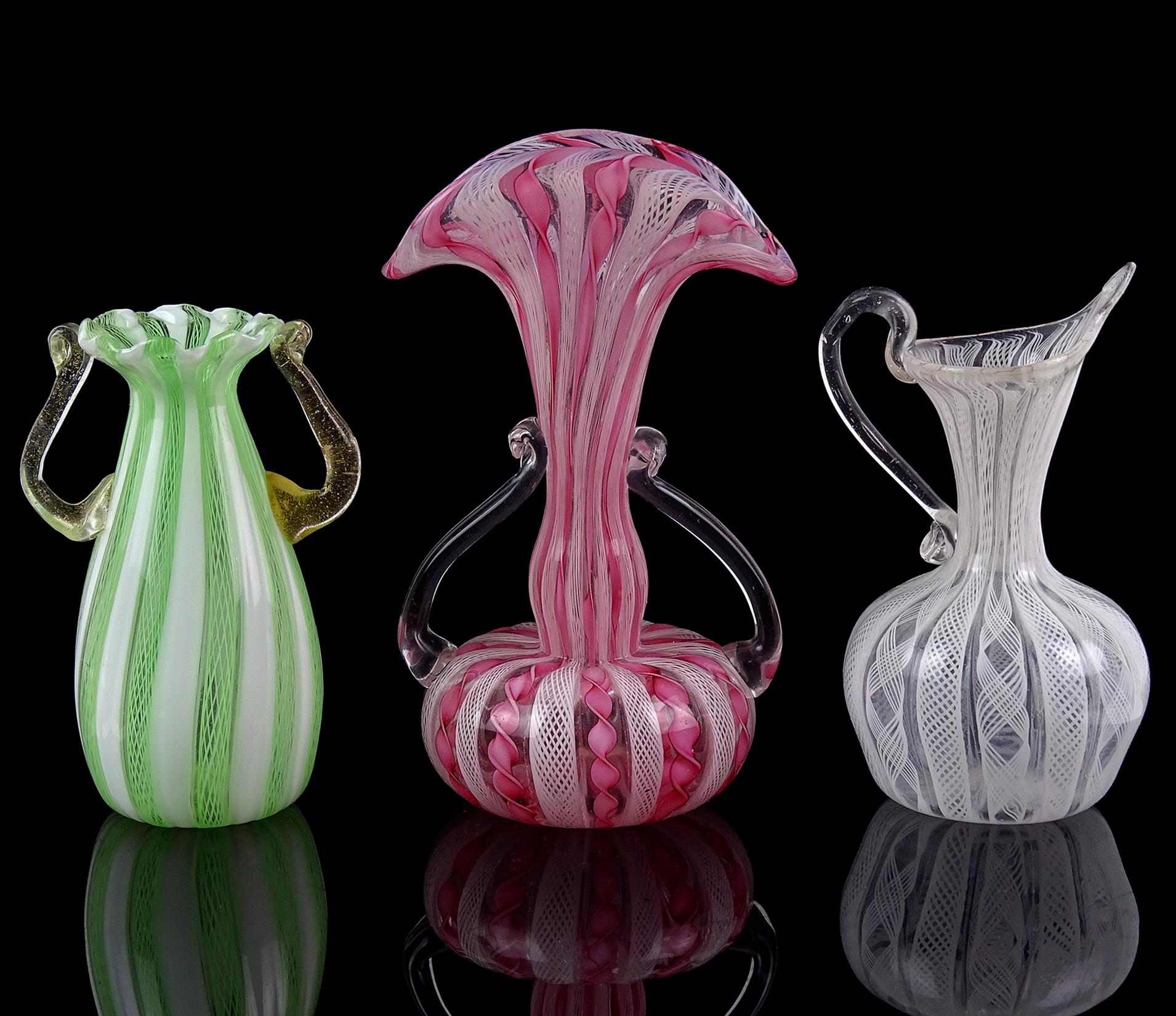 Beautiful set of 3 Murano, Venetian style ribbons Italian art glass cabinet vases. Created in the manner of the Salviati and Fratelli Toso companies. Each vase has a unique design. The first, has green Zanfirico ribbons with white canes. Has a