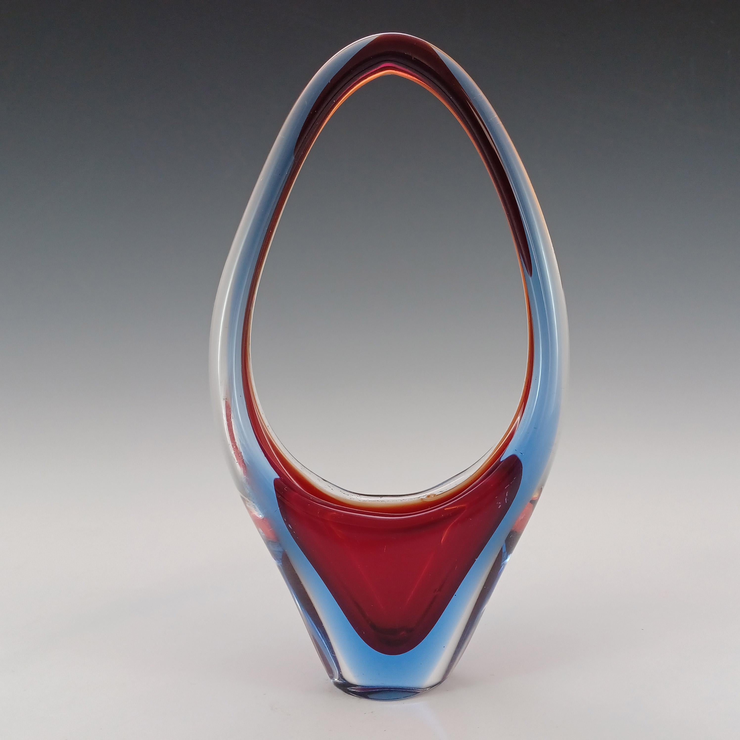 A Venetian organic glass basket shaped vase or bowl, made on the island of Murano, near Venice, Italy. In a stunning combination of orangey red glass cased in blue glass, which is further encased in clear glass, using the renowned Venetian sommerso