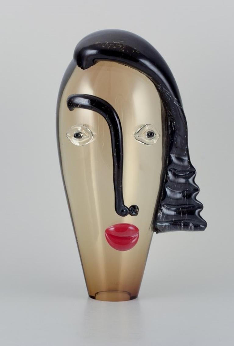 Murano, Venice, Italy. Unique art glass sculpture with a female face. 
Mouth-blown glass.
Approximately from the 1980s.
In excellent condition.
Dimensions: H 37.0 cm x D 19.0 cm.