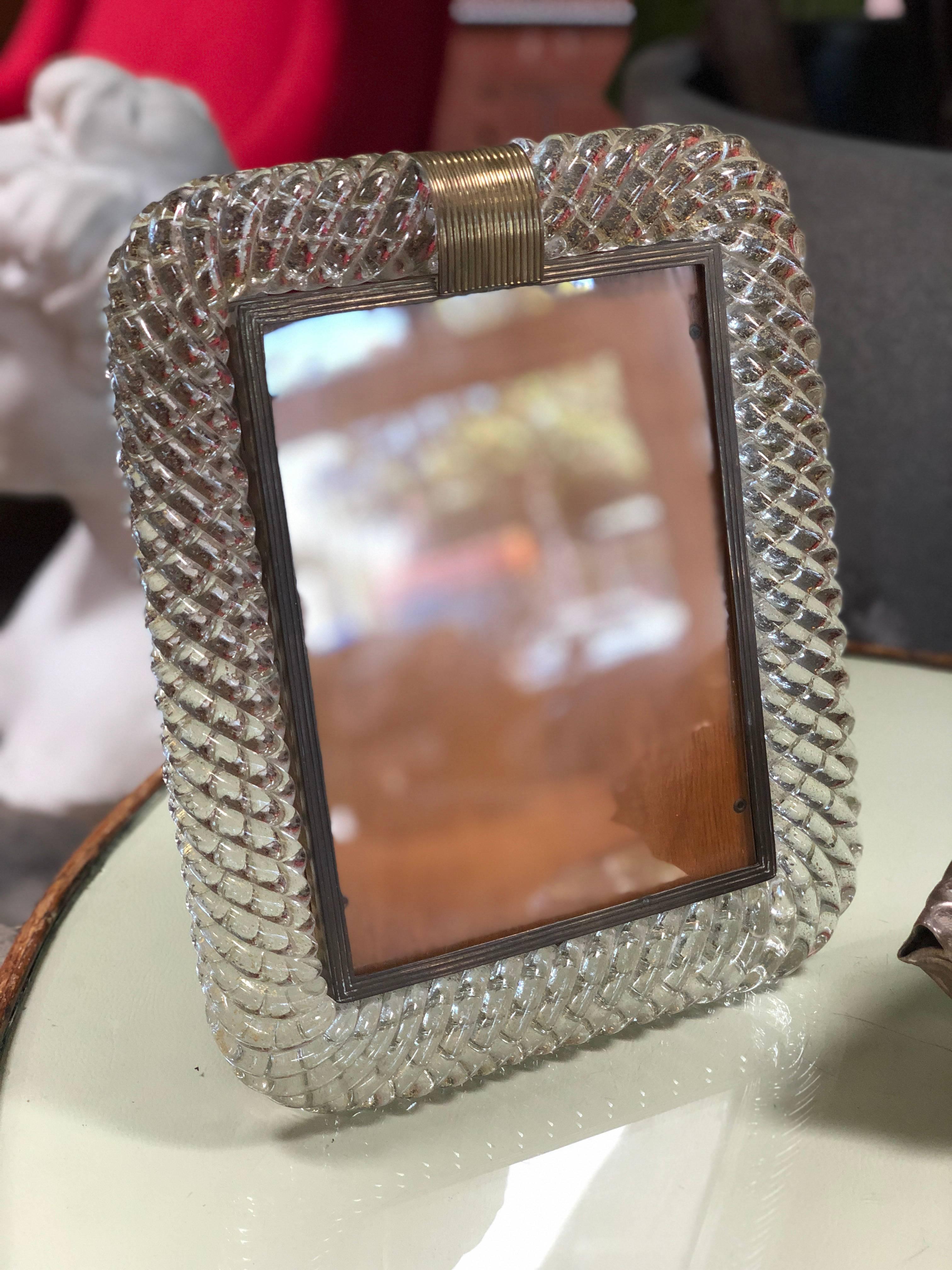 Venini table picture frame in glass and brass, Italy, 1940s with original 'easel' support.
Rare heavy Murano Venini glass frame with incredible braided texture, brass accent.