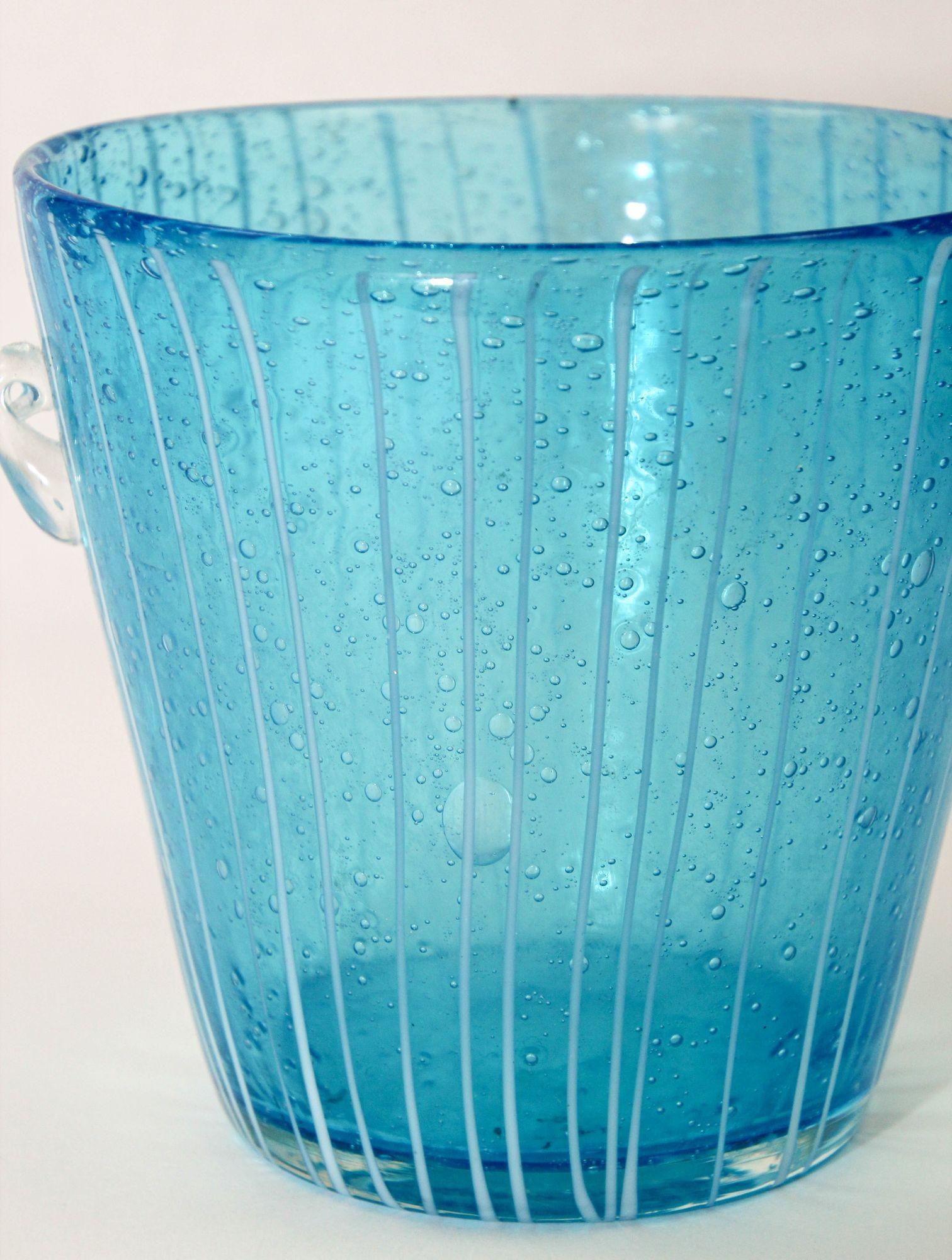 1980s Vintage Venini Murano Light Blue White and Clear crystal Wine Cooler Ice Bucket Made in Italy.
handcrafted Italian Murano Venini venetian art glass ice bucket .
This is a delicate blown Murano crystal blown glass ice bucket.
It has a flared