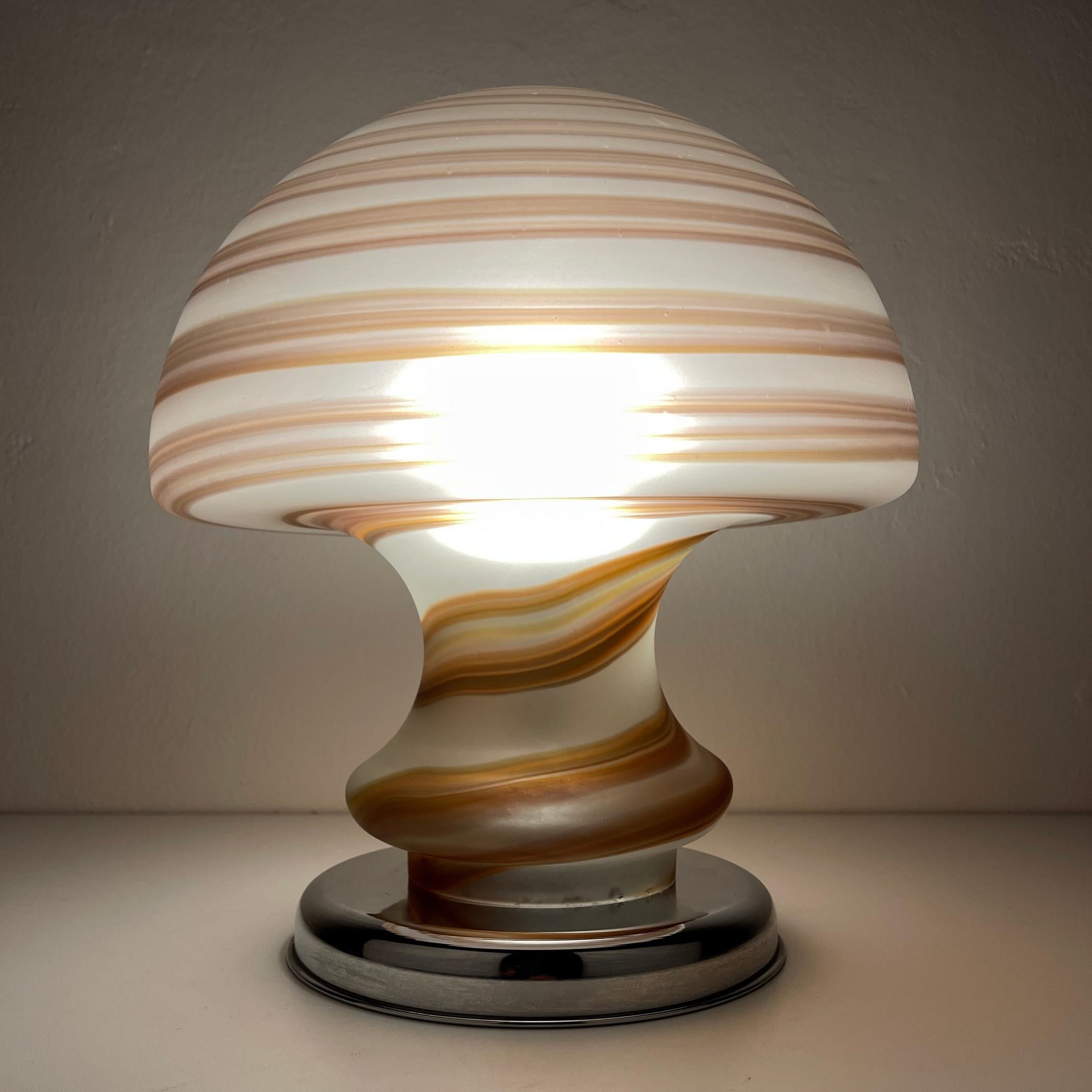 The mushroom swirl Murano glass table lamp made in Italy in the 1970s.
The lamp is suited for regular E14 light bulb and, suited for both 110V and 220V grids. It has an EU-spec plug. Cable length 135 cm. Wiring replaced by a professional