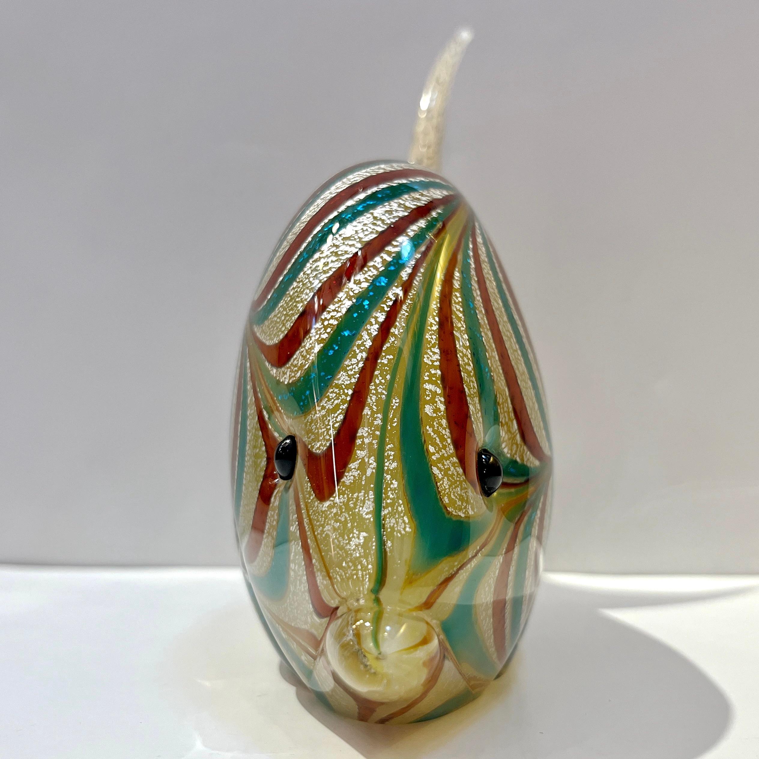 1960s Italian mid-century modern sculptural Murano glass fish of exquisite craftmanship, attributed to Archimede Seguso. It is realized using the Sommerso technique, a crystal clear layer of glass, blown over the amber stone color glass core,