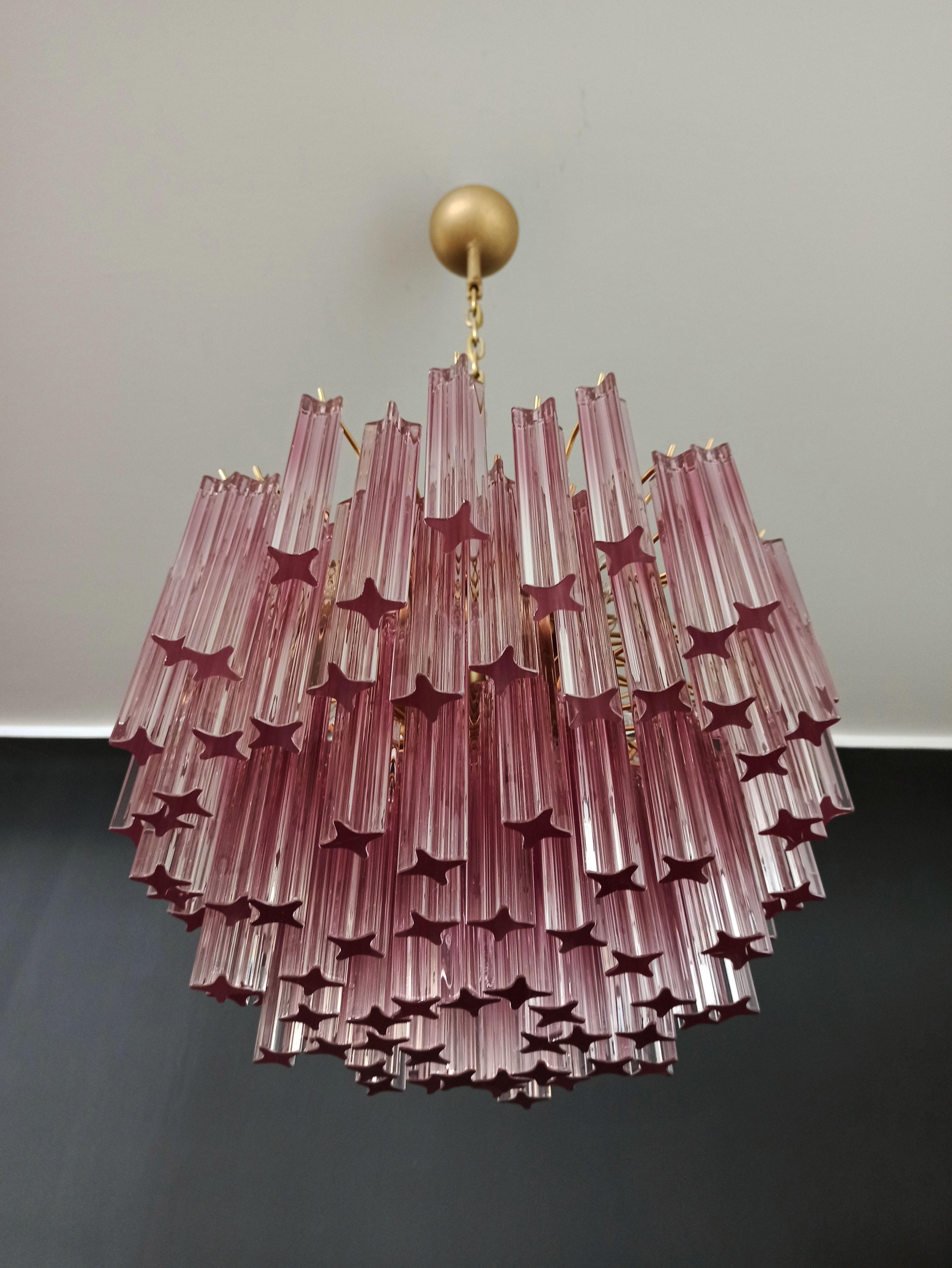 Fantastic vintage Murano chandelier made by 107 Murano crystal prism quadriedri in a painted gold metal frame. The glasses: quadriedri amethyst shade
Period: 1980's
Dimensions: 45.25 inches height (115 cm) with chain; 15.75 inches height (40 cm)
