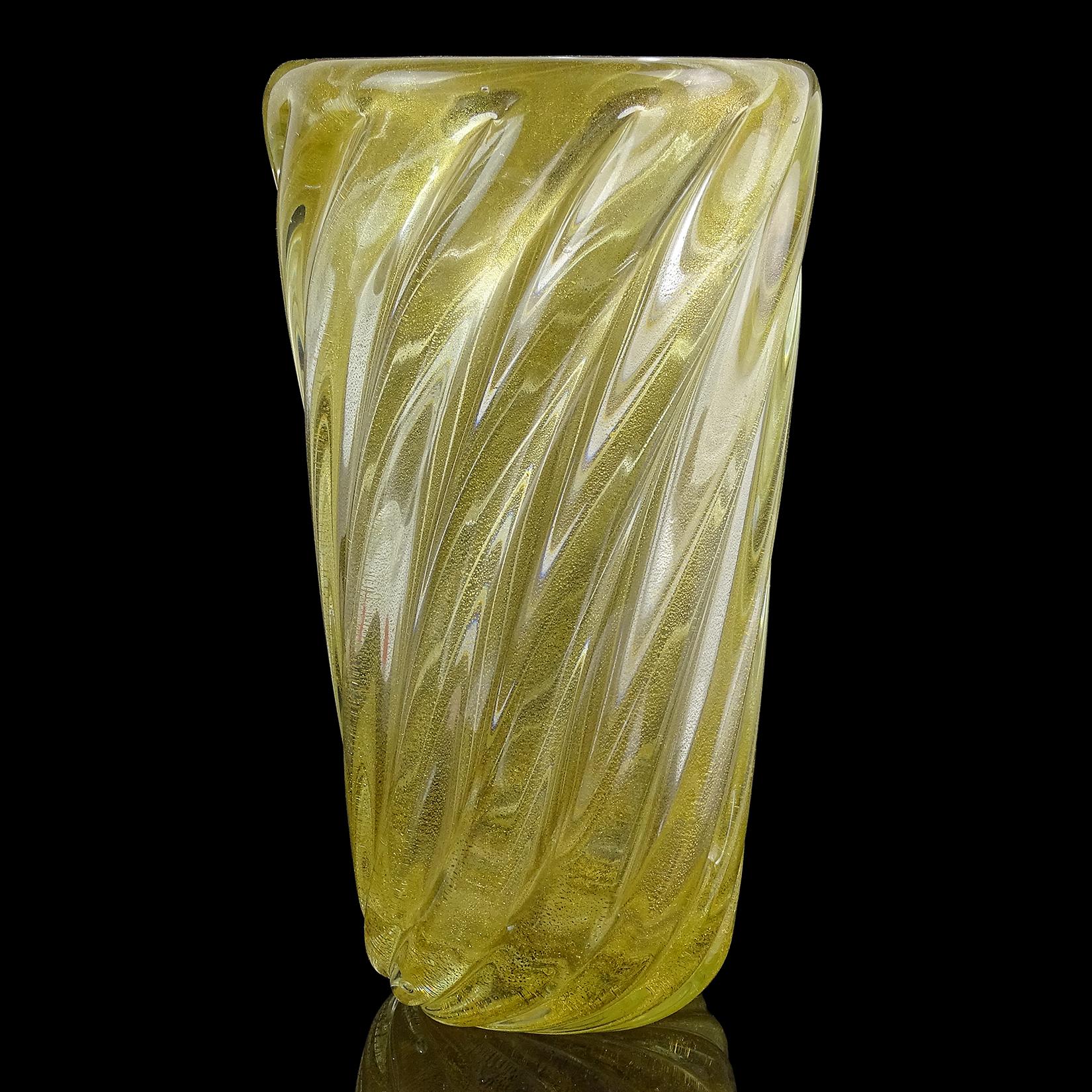 Beautiful vintage Murano hand blown gold flecks Italian art glass flower vase. The piece is profusely covered in gold leaf, with ribbed design. Made with very thick glass. Created in the manner of the Seguso Vetri d'Arte company, and designer