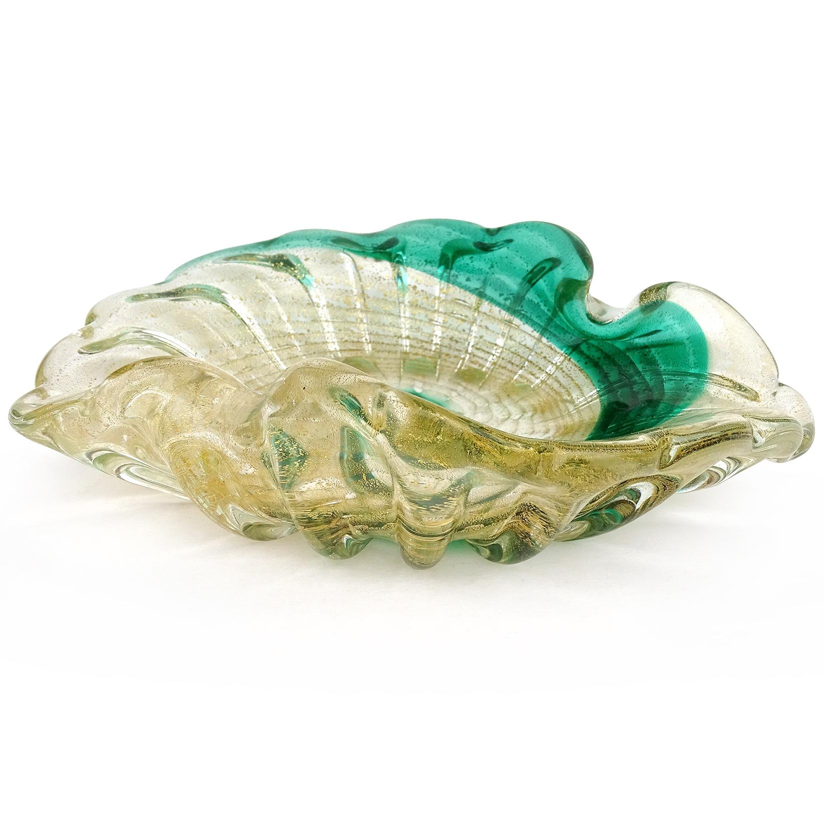 Beautiful vintage Murano hand blown green, with gold flecks Italian art glass bowl. The bowl has a painterly swirl, ribbed pattern along the outside, and is profusely covered in gold leaf. Can be used as a display piece on any table. Created in the