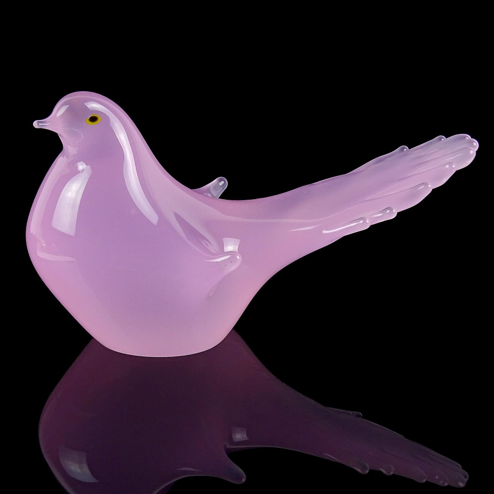 Beautiful vintage Murano hand blown pink opalescent Italian art glass dove bird sculpture. The bird has an elegant shape, with yellow and black eyes. It has a fanned out tail, with wings close to the body. Created in the manner of designer Archimede