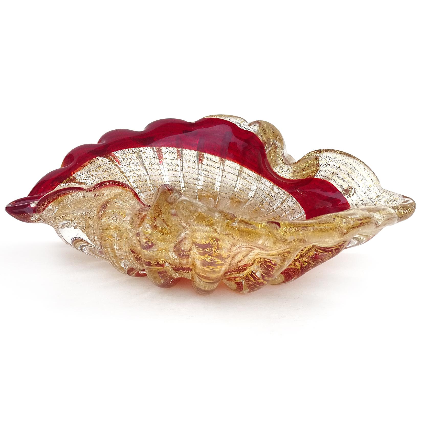 Beautiful vintage Murano hand blown red, with gold flecks Italian art glass bowl. The bowl has a painterly swirl, ribbed pattern along the outside, and is profusely covered in gold leaf. Can be used as a display piece on any table. Created in the