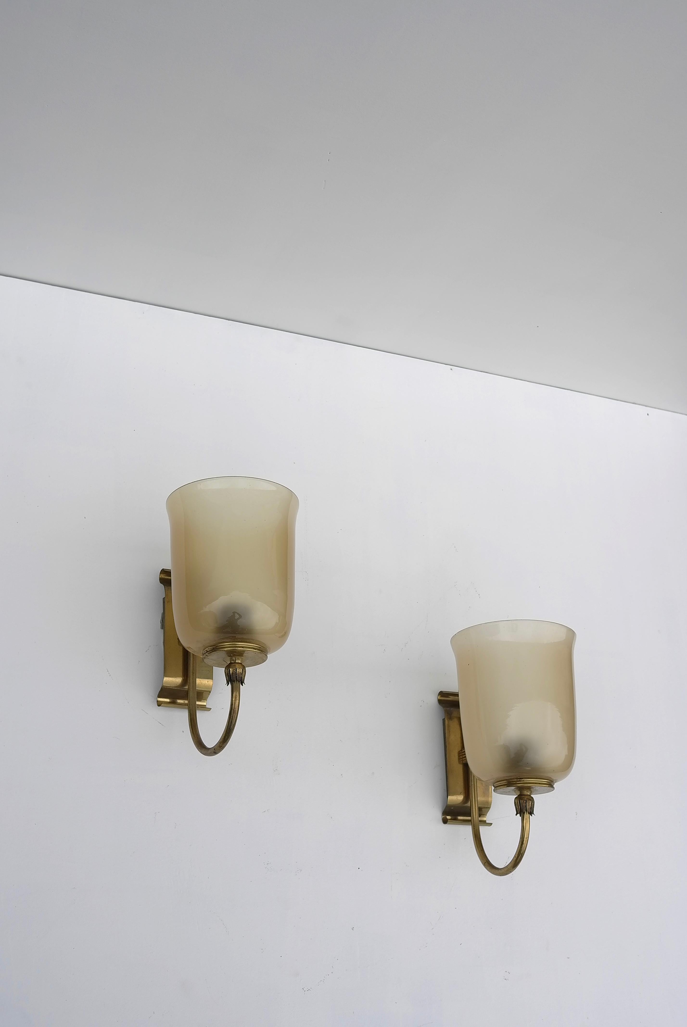 Murano wall lamps in champagne amber color glass and brass details, Italy 1950's.
