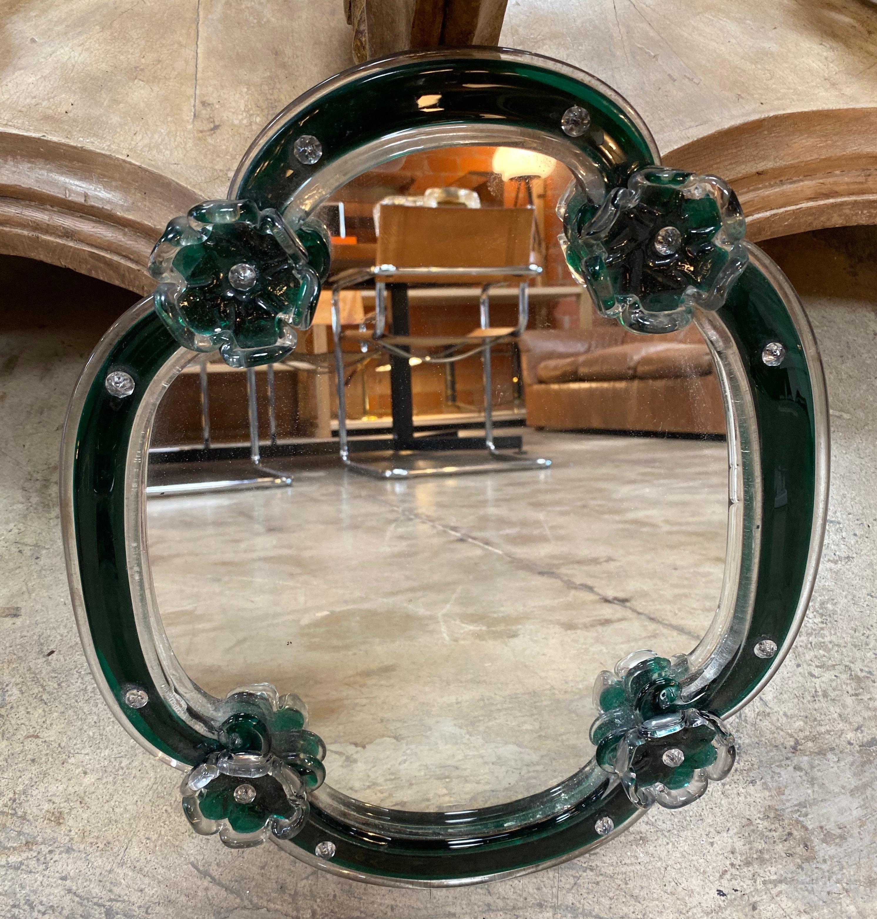 This presented charming oval wall mirror is decorated with flowers and made in Murano by Venini
It exists a loop for hang up.
The condition is very good.