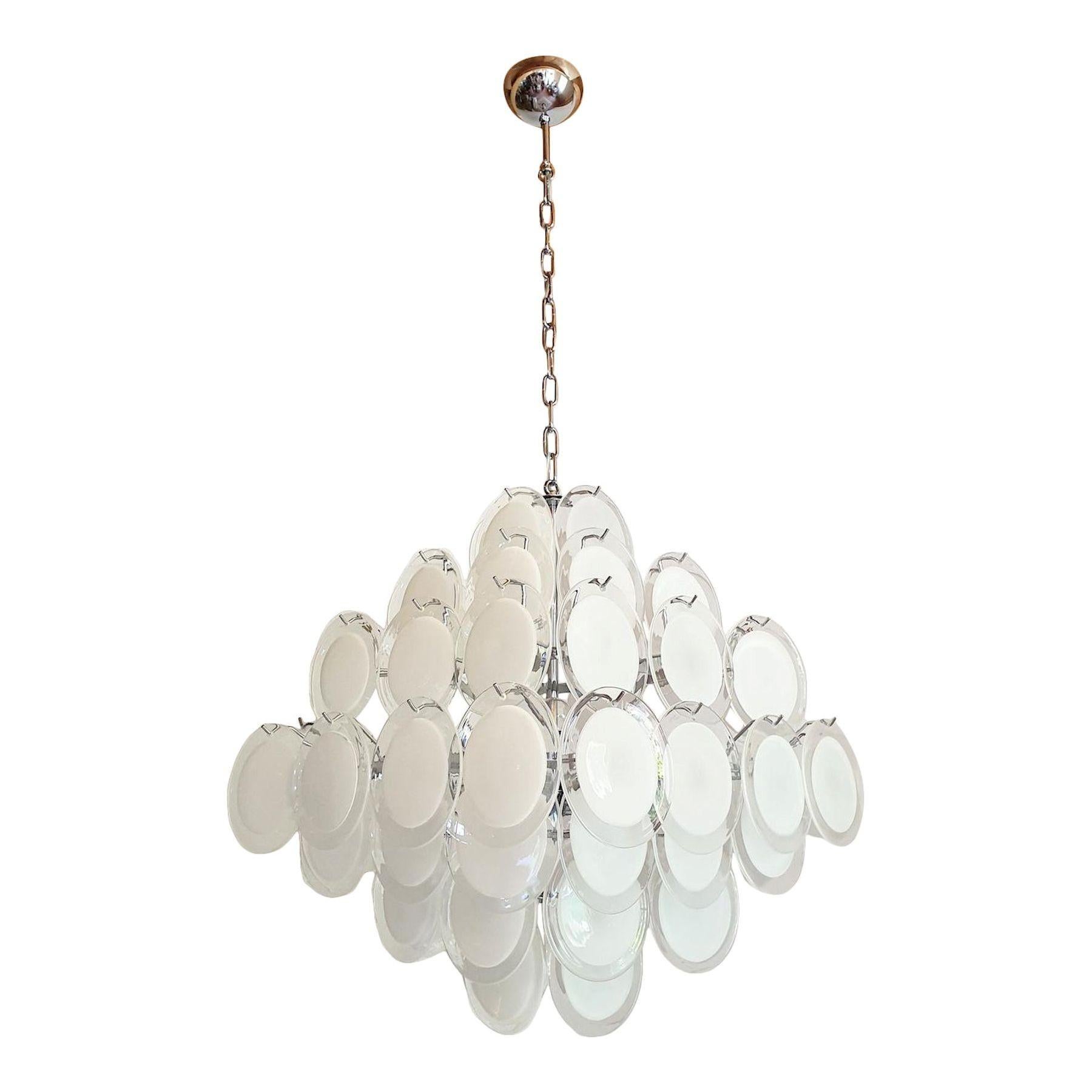 A large modernist pyramidal geometric discs chandelier, by Vistosi Italy 1980s.
The Mid Century Modern chandelier is made of a chrome frame, and white Murano handmade glass discs.
Each handmade Murano disc is white and translucent at the center, and