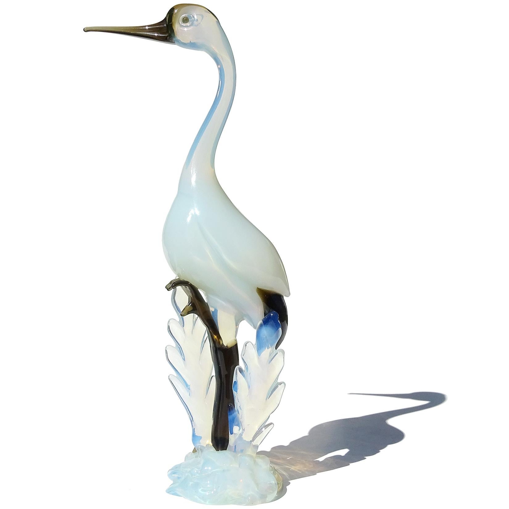 Beautiful and tall, vintage Murano hand blown opalescent white and dark live green Italian art glass Crane bird figure / sculpture. Documented to the Seguso Vetri d'Arte company, circa 1954. The bird is published in their book, page 138, model #9719