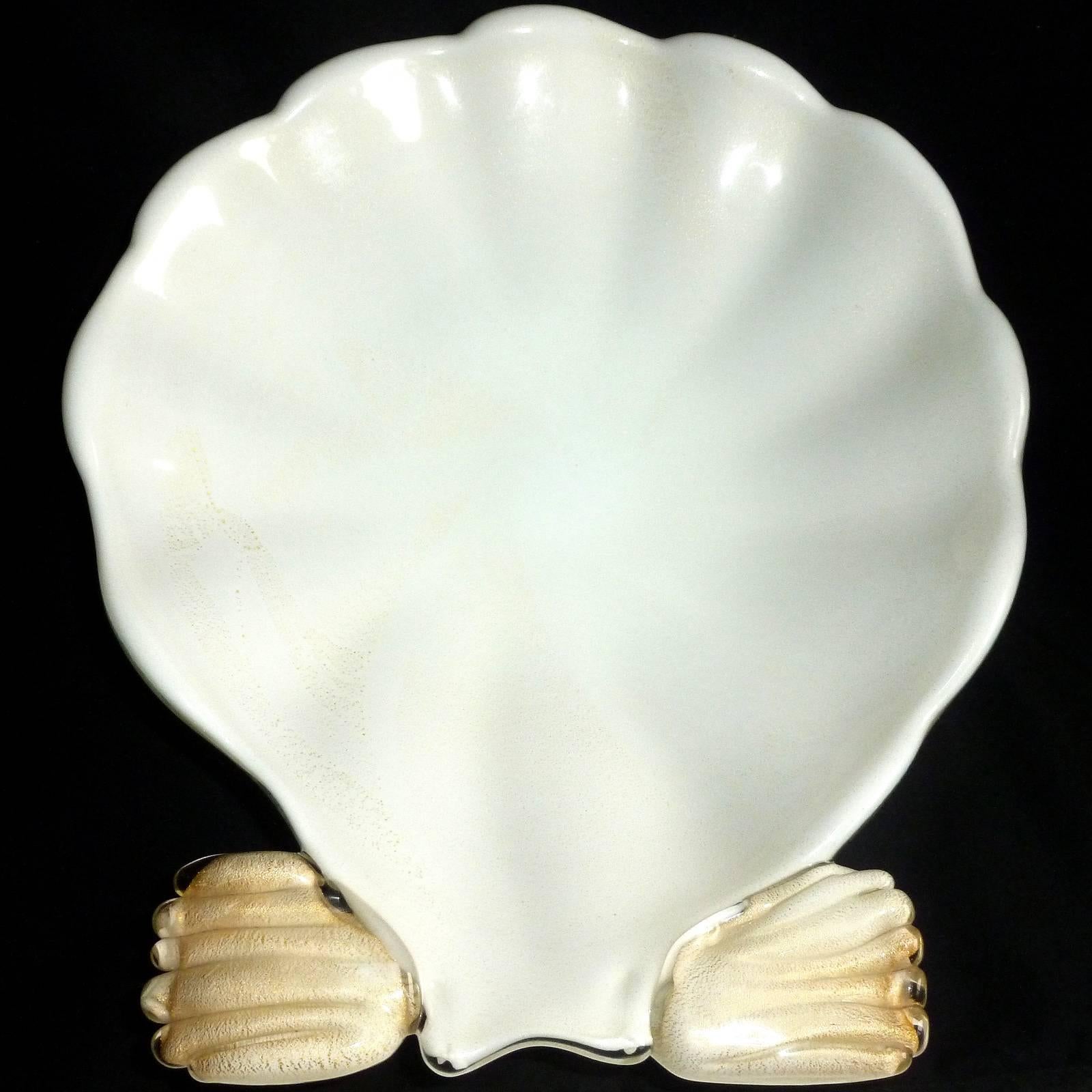 Gorgeous set of vintage Murano hand blown white and gold flecks Italian art glass conch shell centerpiece bowl and matching seashell candlesticks. All three pieces are profusely covered with gold leaf, inside and out, and stand on gold pedestals.