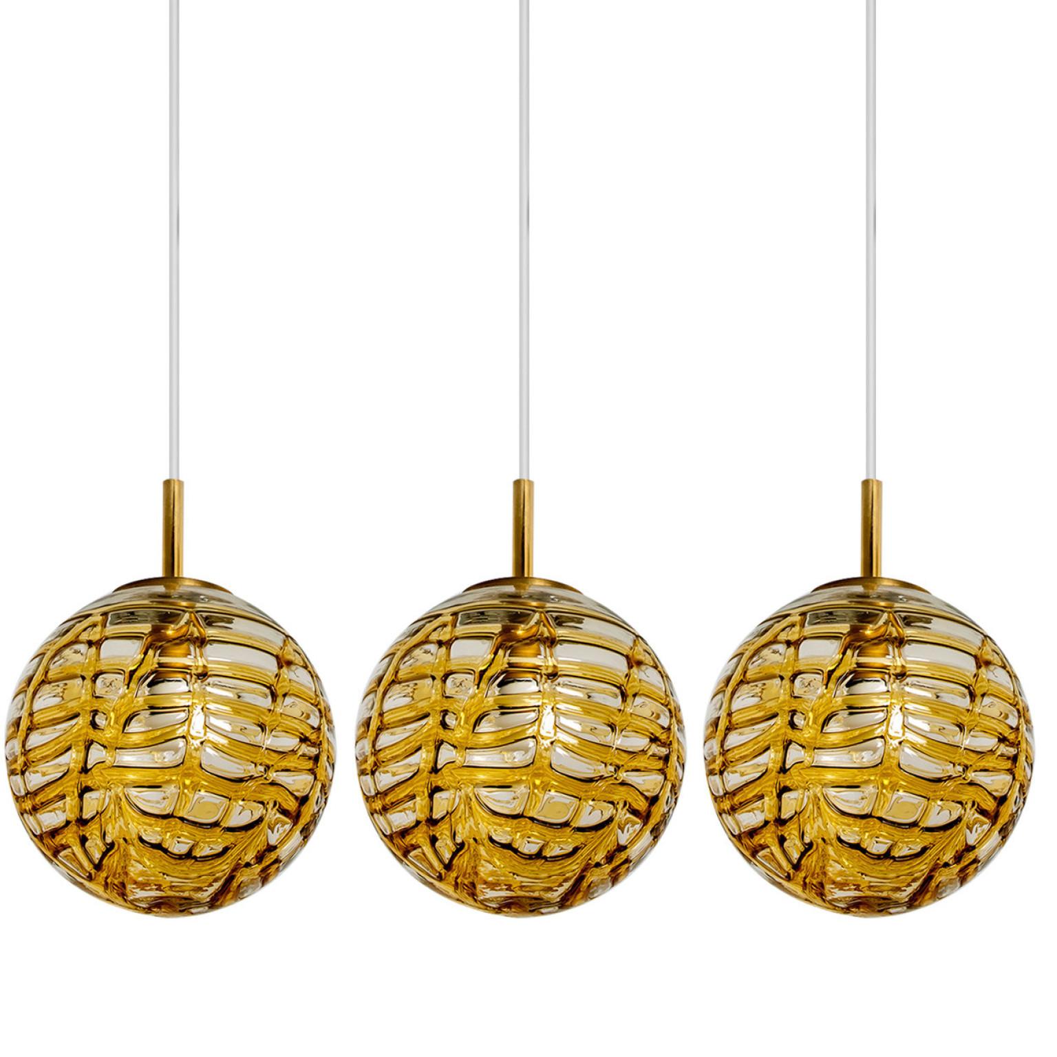 One of the three Doria pendant lights (in collaboration with Murano) in the style of Venini, manufactured, circa 1960. Real statement pieces.
High-end thick Murano crystal glass shade made out of overlay glasses in the color yellow, applied in
