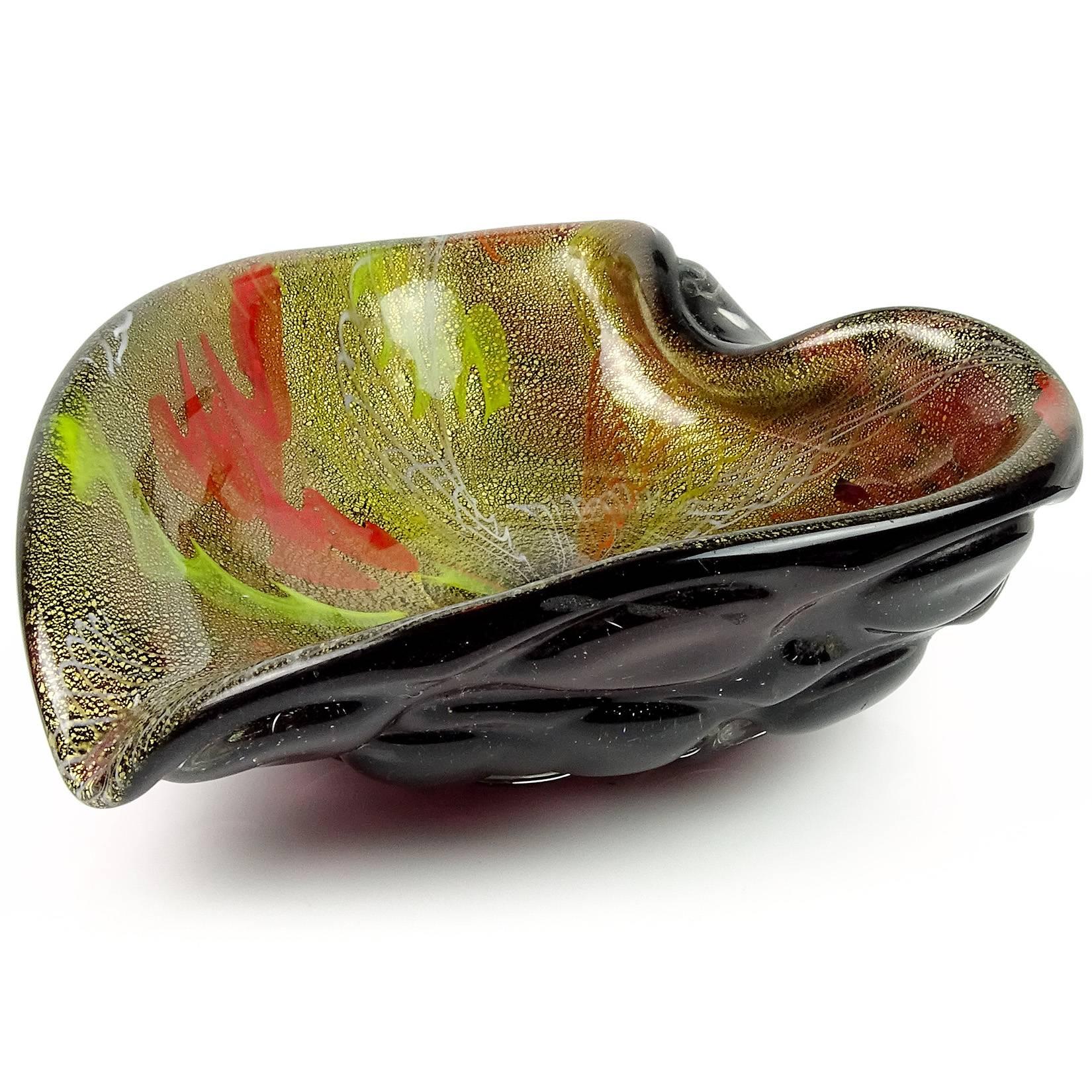 Beautiful Murano hand blown dark purple, yellow, white and orange ribbons Italian art glass heart shaped bowl. Created in the style of designer Dino Martens. The piece is profusely covered in gold leaf, with a sculptural bubble body. Measures: 6