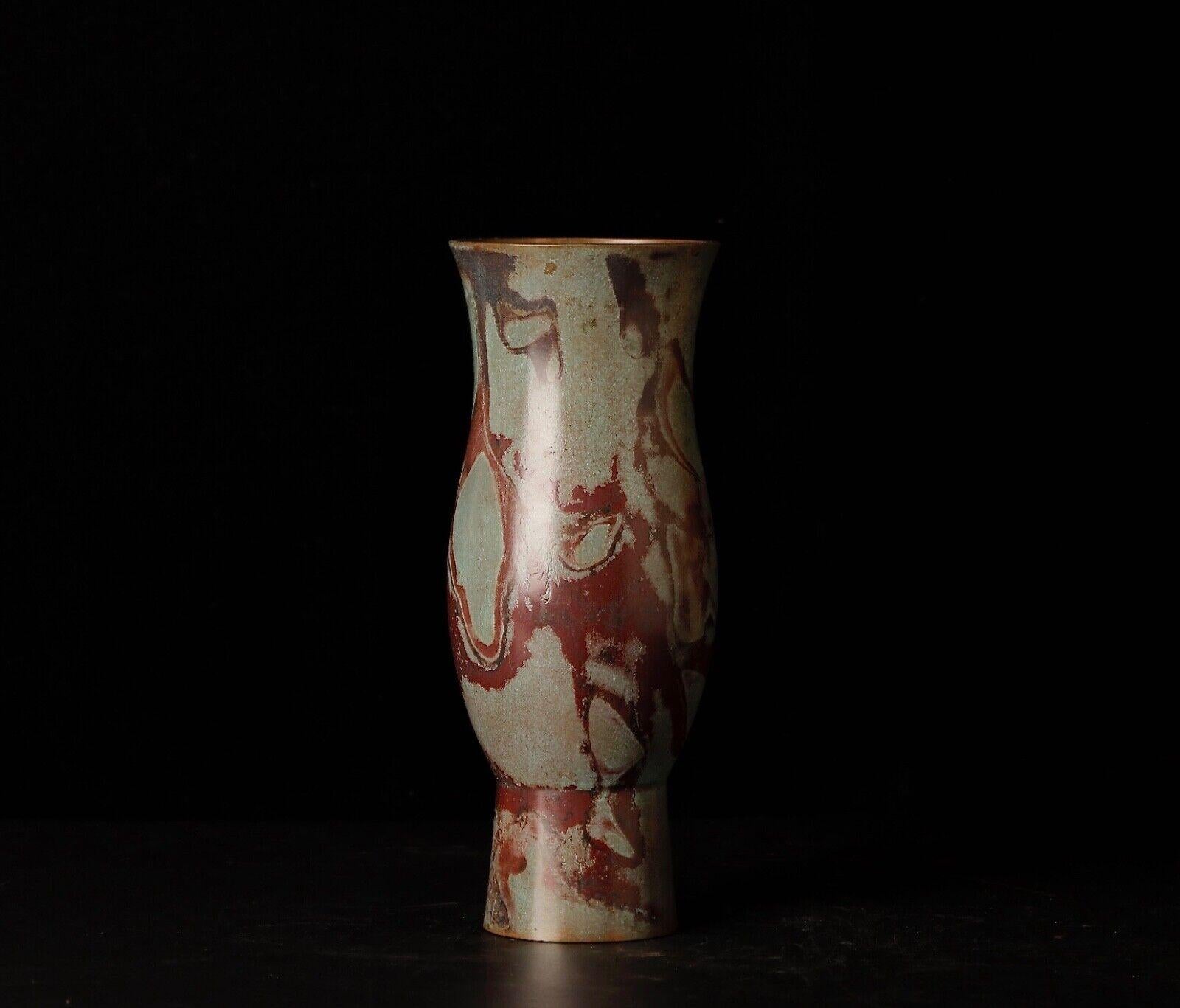 Delve into the art of Japanese metalwork with this striking Murashido bronze vase, crafted by the esteemed artist Hozan. Murashido is a traditional technique involving the application of heat and special oils to bronze, creating unique, mottled