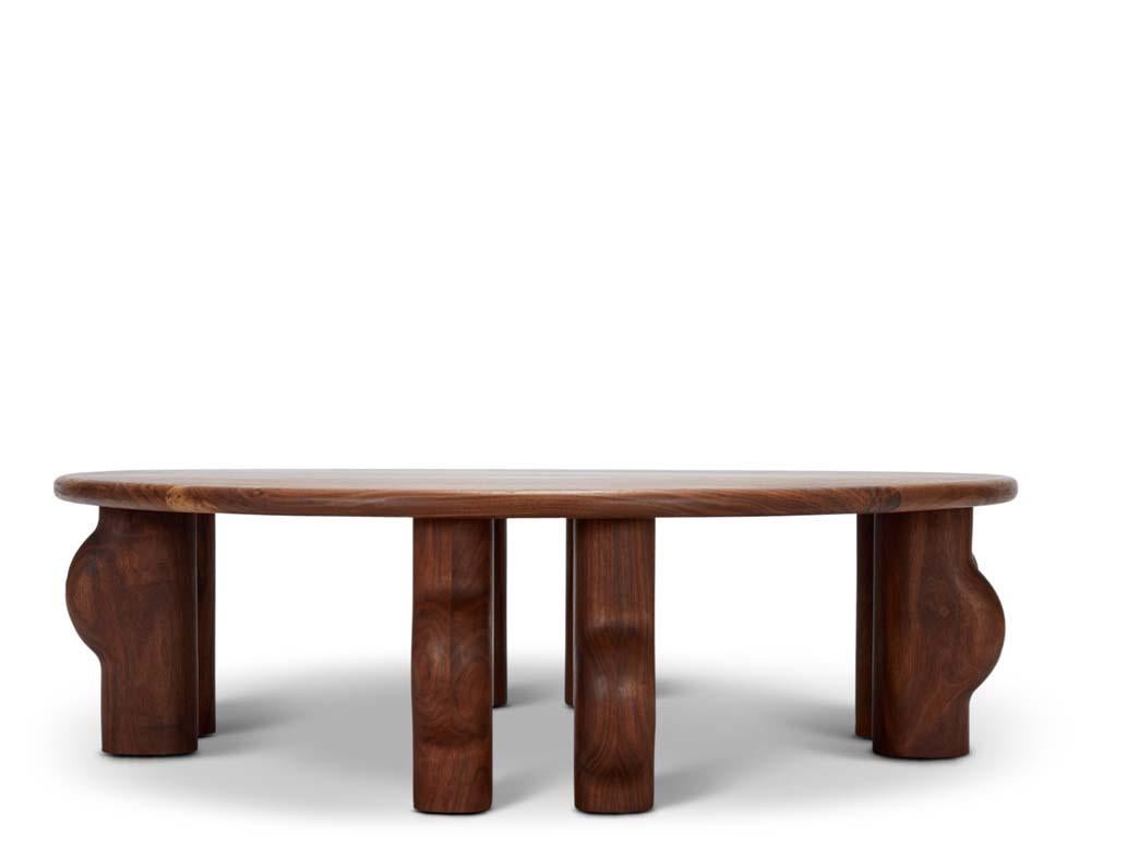 Murici Coffee Table. The Murici table features asymmetrical chunky legs rounded to expose a marbling effect in the wood. The Murici tables are named after a wild little berry that grows in the north of Brazil. The plant has deep green leaves and its