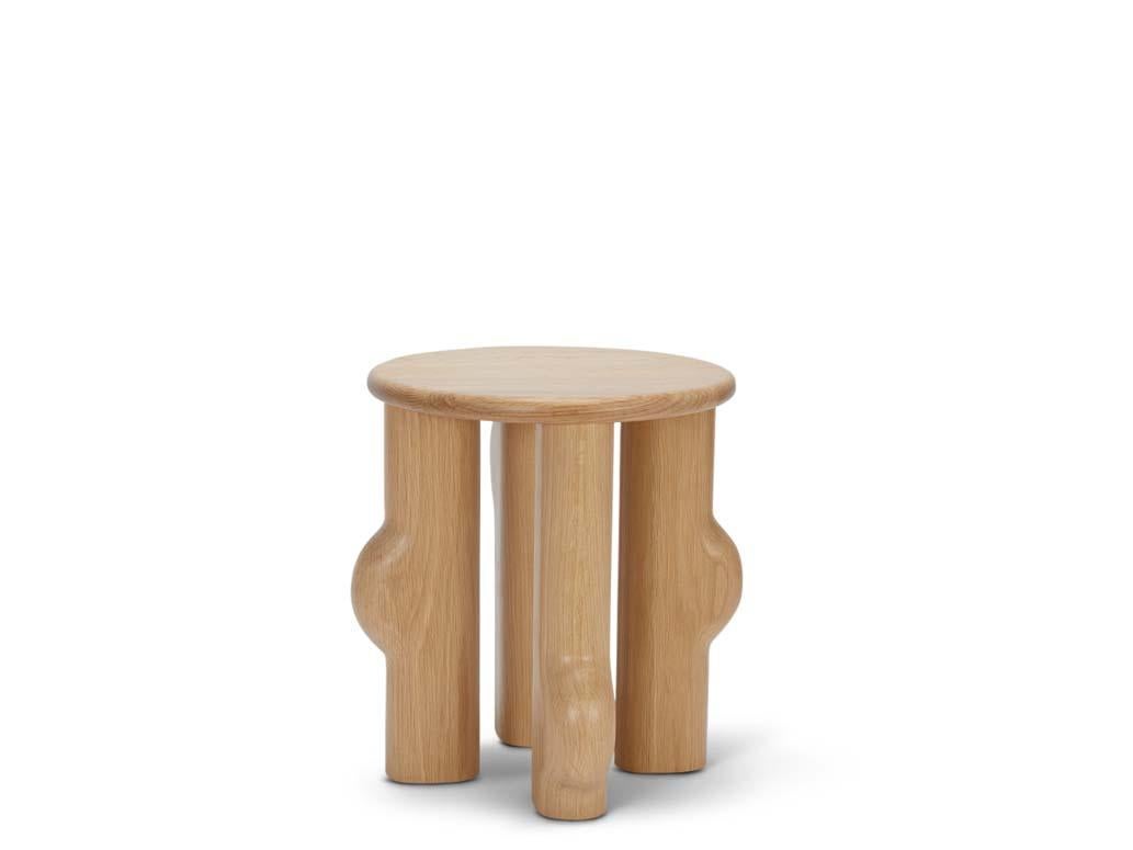 Murici Side Table. The Murici Side Table features asymmetrical chunky legs rounded to expose a marbling effect in the wood. The Murici tables are named after a wild little berry that grows in the north of Brazil. The plant has deep green leaves and