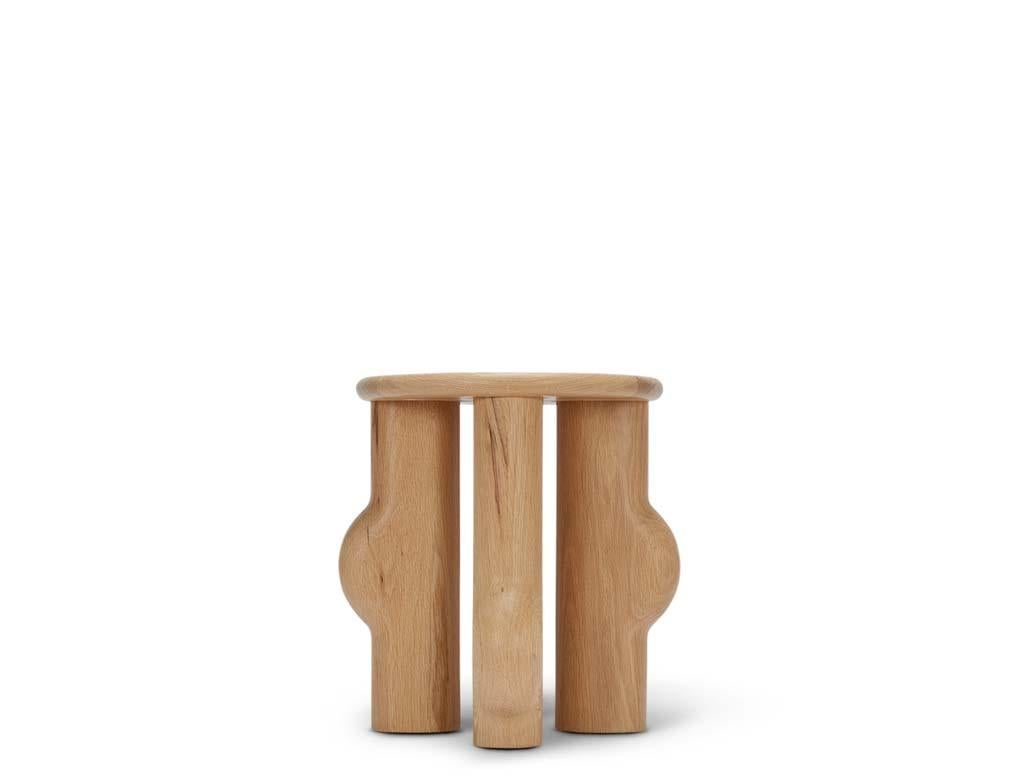 Murici Side Table. The Murici Side Table features asymmetrical chunky legs rounded to expose a marbling effect in the wood. The Murici tables are named after a wild little berry that grows in the north of Brazil. The plant has deep green leaves and