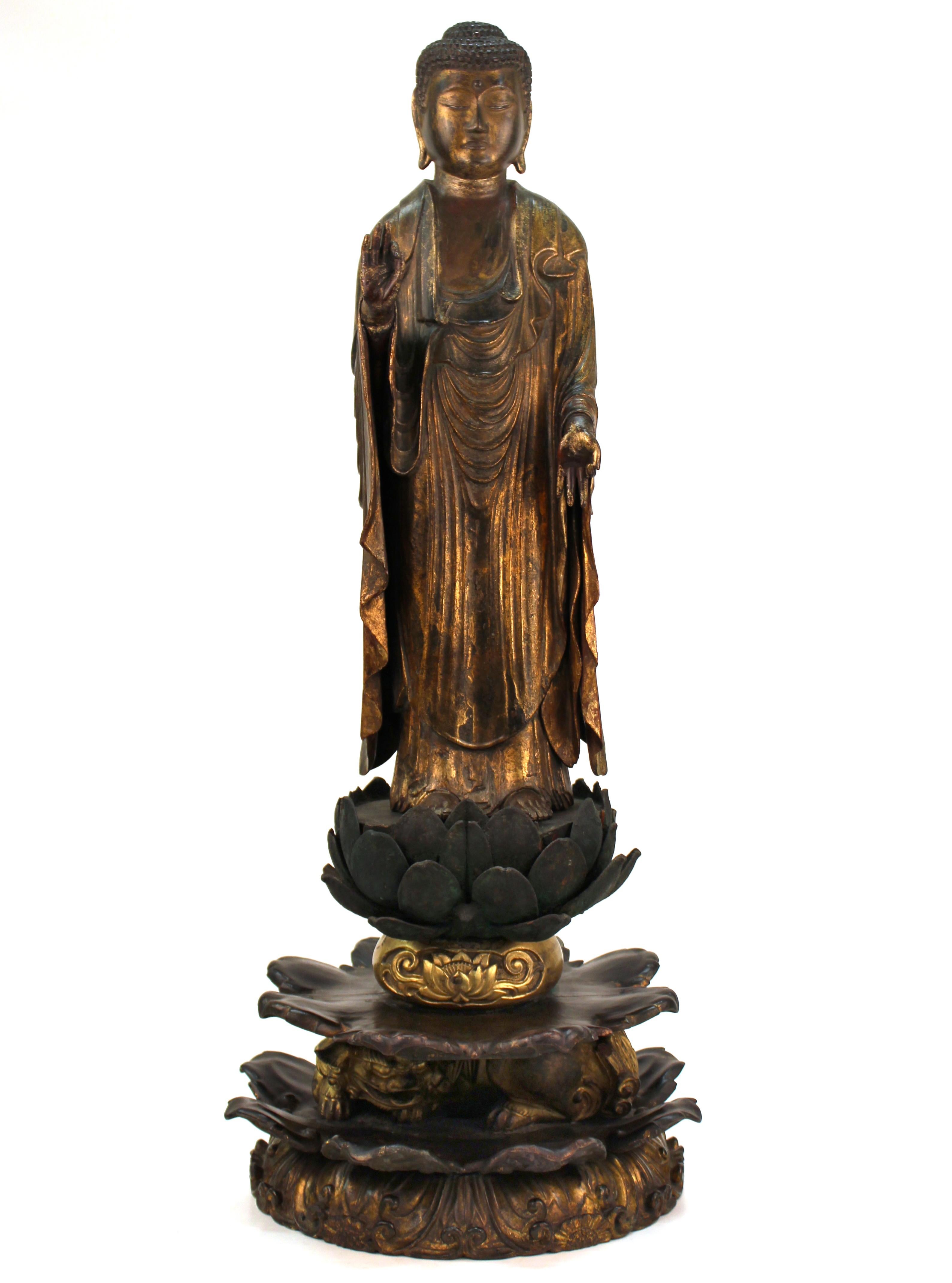 A Japanese carved and gilt wood Buddha figure Amida Nyorai (Buddha Amitabha), 15th C. Sengoku Cypress wood with traces of pigment and lacquer gold leaf. Standing  on a lotus and a gold lacquer Zishi . This important masterpiece is exquisitely caved.