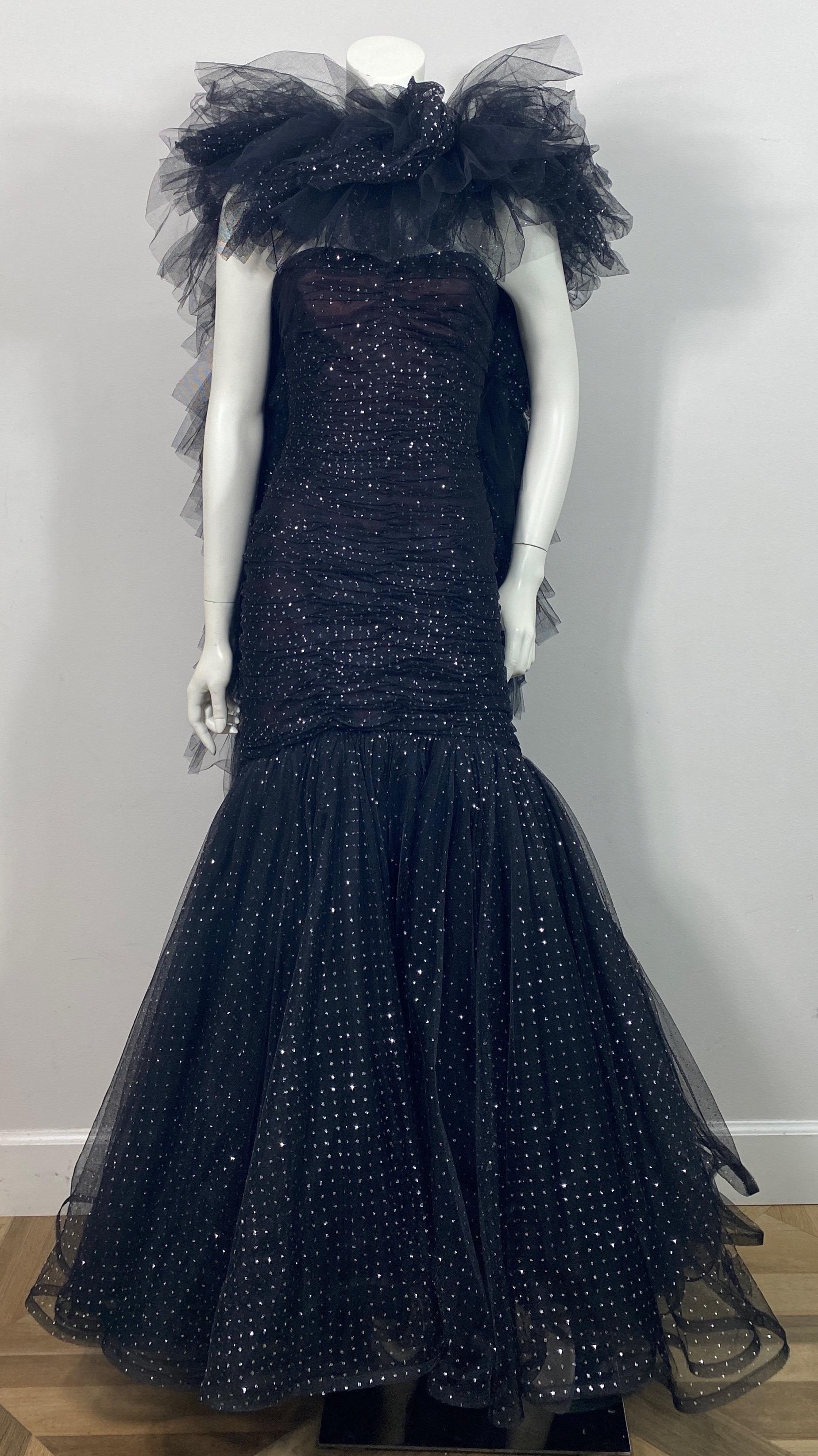 Murray Arbeid 1990 Black and Silver Tulle Gown with boa style shawl - Size 8 This late 1980’s or Early 1990’s gown is made of multi layers of tulle and a Black Point D’Esprit that has silver detail. The top bodice of the strapless gown has a built