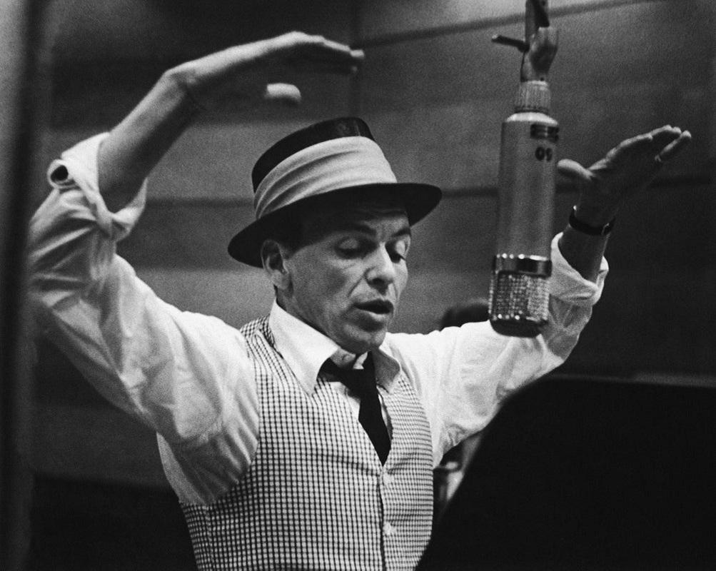 "Frank Sinatra Recording Session" by Murray Garrett

American singer and actor Frank Sinatra (1915 - 1998) gestures with his hands while singing into a microphone during a recording session in a studio at Capitol Records, early