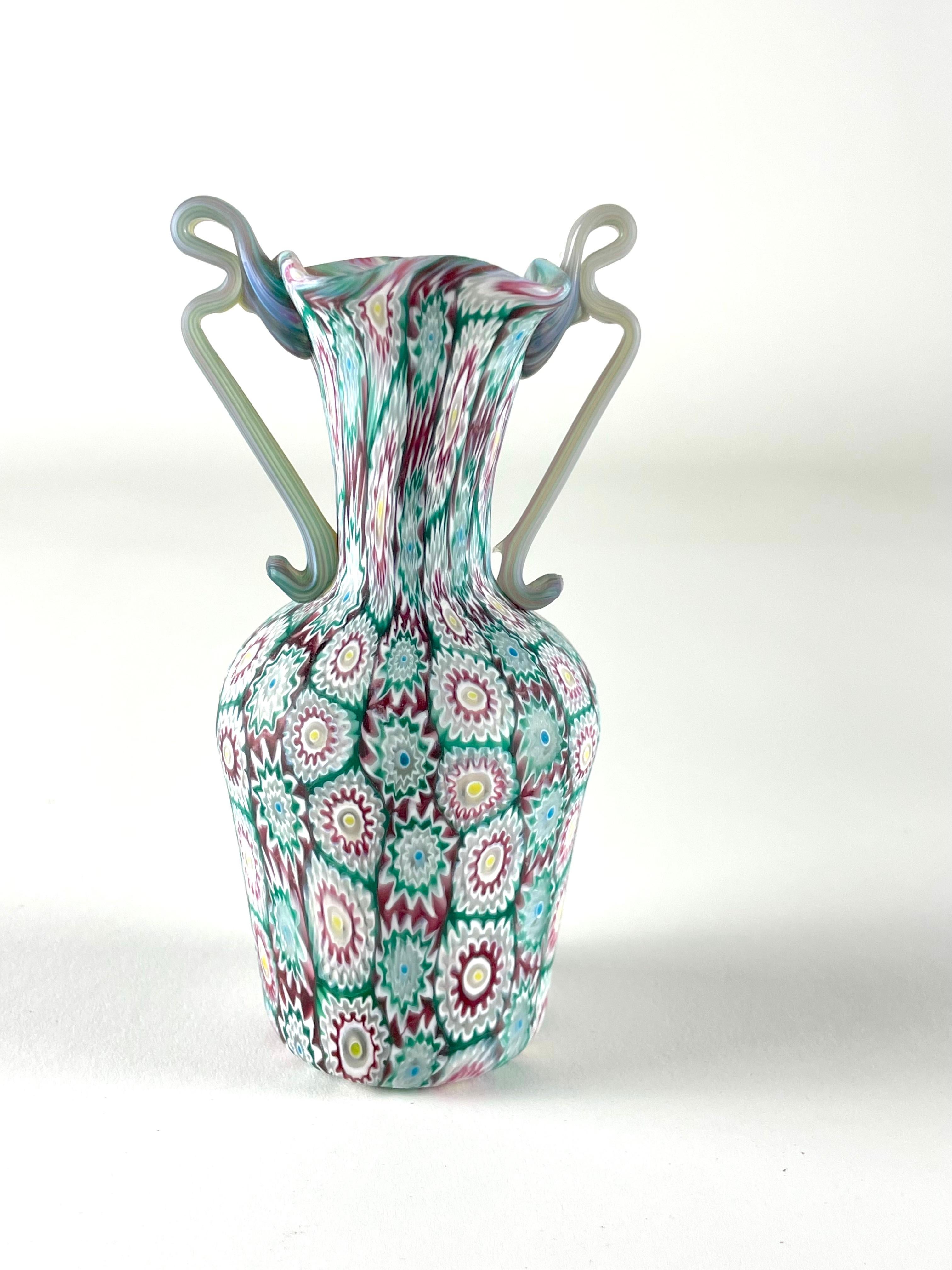 It is a set of two beautiful examples of murrina small vases by Fratelli Toso glass factory. Realized around 1920 these are realized with polychrome multicoloured millefiori murrines and have an acid etched matte finish. The vases are authentic